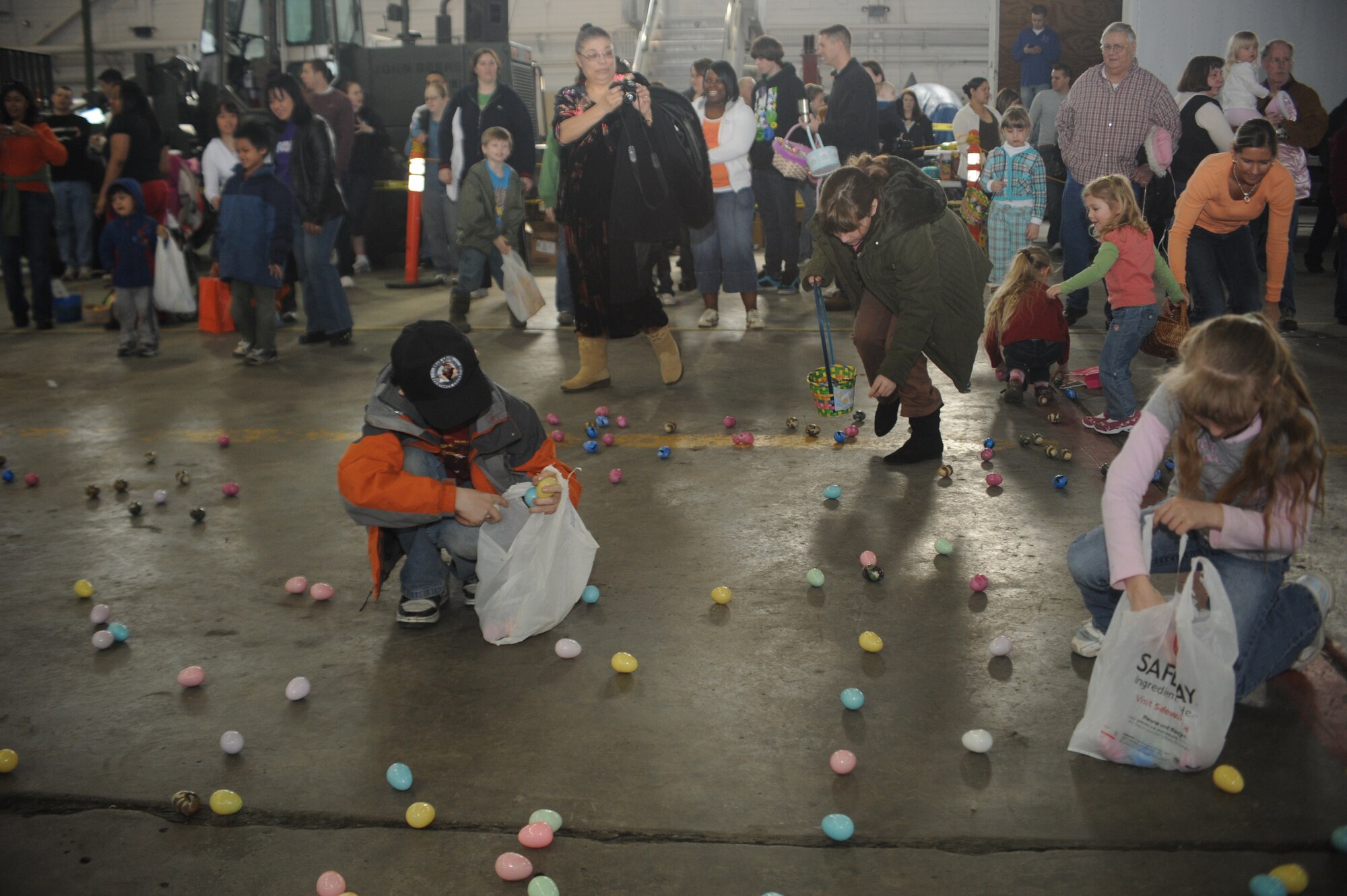 ELMENDORF AIR FORCE BASE, Alaska-- Parents onlook as children of all ages gather Easter eggs during Elmendorf's annual EGGstavaganza on April 11, 2009. The eggs contained various items from assorted candies to gift tags redeemable for everything from Elmo play sets to mountain bikes. (U.S. Air Force photo by Airman First Class Kristin High)