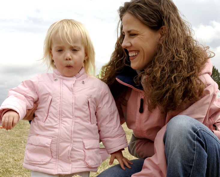 Kristen, 2, pauses for a piece of candy with her mother, Emily Malmgren, during the Easter egg hunt at the Community Deel Center April 11. The hunt was just one of the activities scheduled for the children. Other activities included face painting, a visit from the Easter bunny and Sparky the Fire Dog, and an inflatable bounce toy. (U.S. Air Force photo / Airman 1st Class Darlene West)