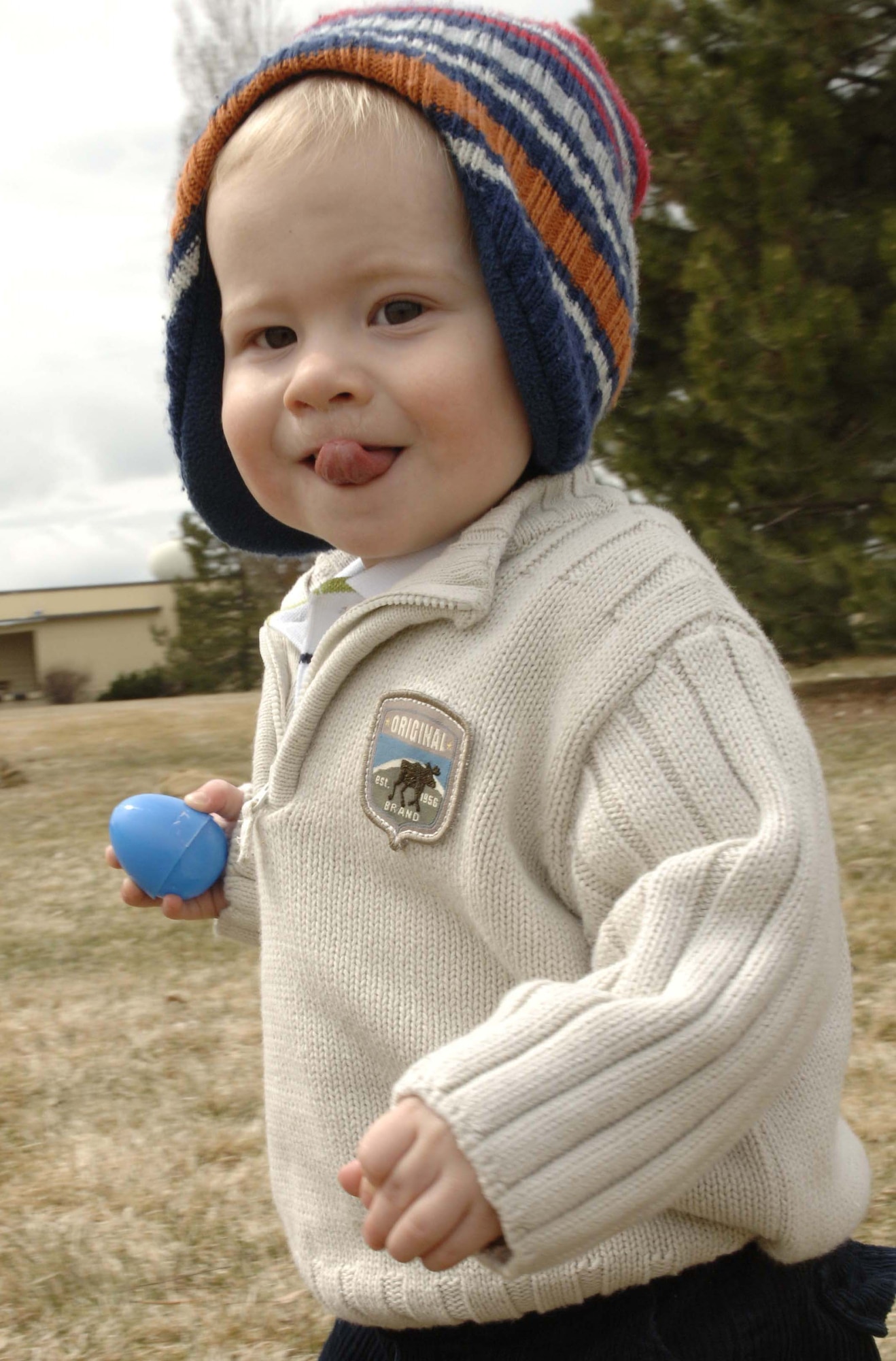 Evan, 2, runs to collect the plastic Easter eggs during the Easter egg hunt at the Community Deel Center April 11. Even the rain didn’t slow the families down from participating in the Easter egg hunt. (U.S. Air Force photo / Airman 1st Class Darlene West)