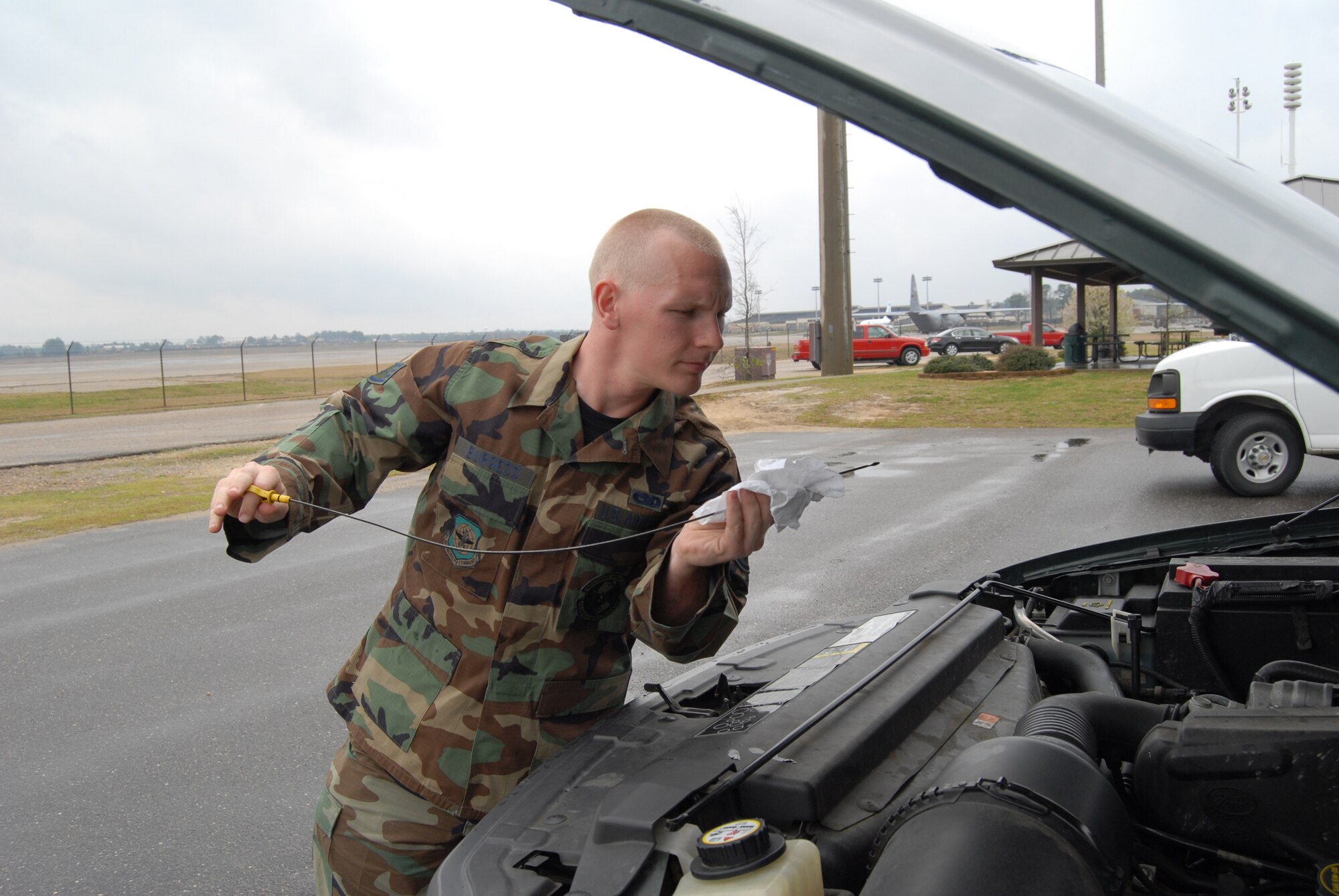 Staff Sgt. Dustin Burgess, 43rd Aircraft Maintenance Squadron, checks the oil on a “Follow Me” vehicle. “Follow Me” trucks are used in front of aircraft to lead them to correct parking spaces. (U.S. Air Force Photo by Emily Farrington-Smith)