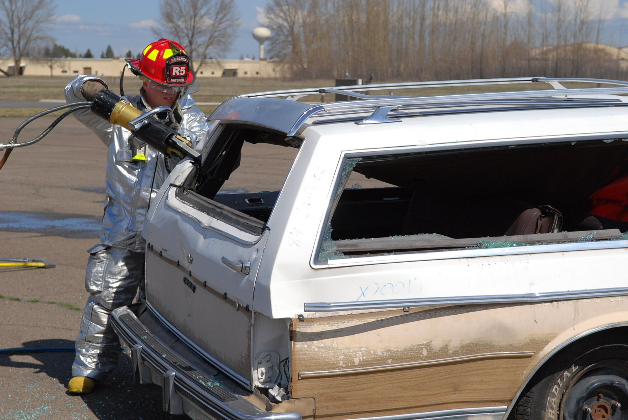 Fairchild Fire Department member uses the Jaws of Life to remove the roof of the vehicle involved in the simulated car crash April 10. (U.S. Air Force photo/Senior Airman Emerald Ralston)