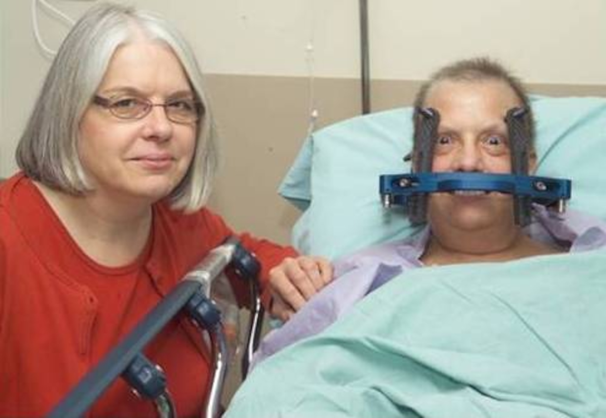 Pamela Bishop fitted with the head frame and awaiting Stereotactic Radiosurgery procedure. She is accompanied by her sister, Barbara Napple. (U.S. Air Force Photo/Mark A. Pugel)