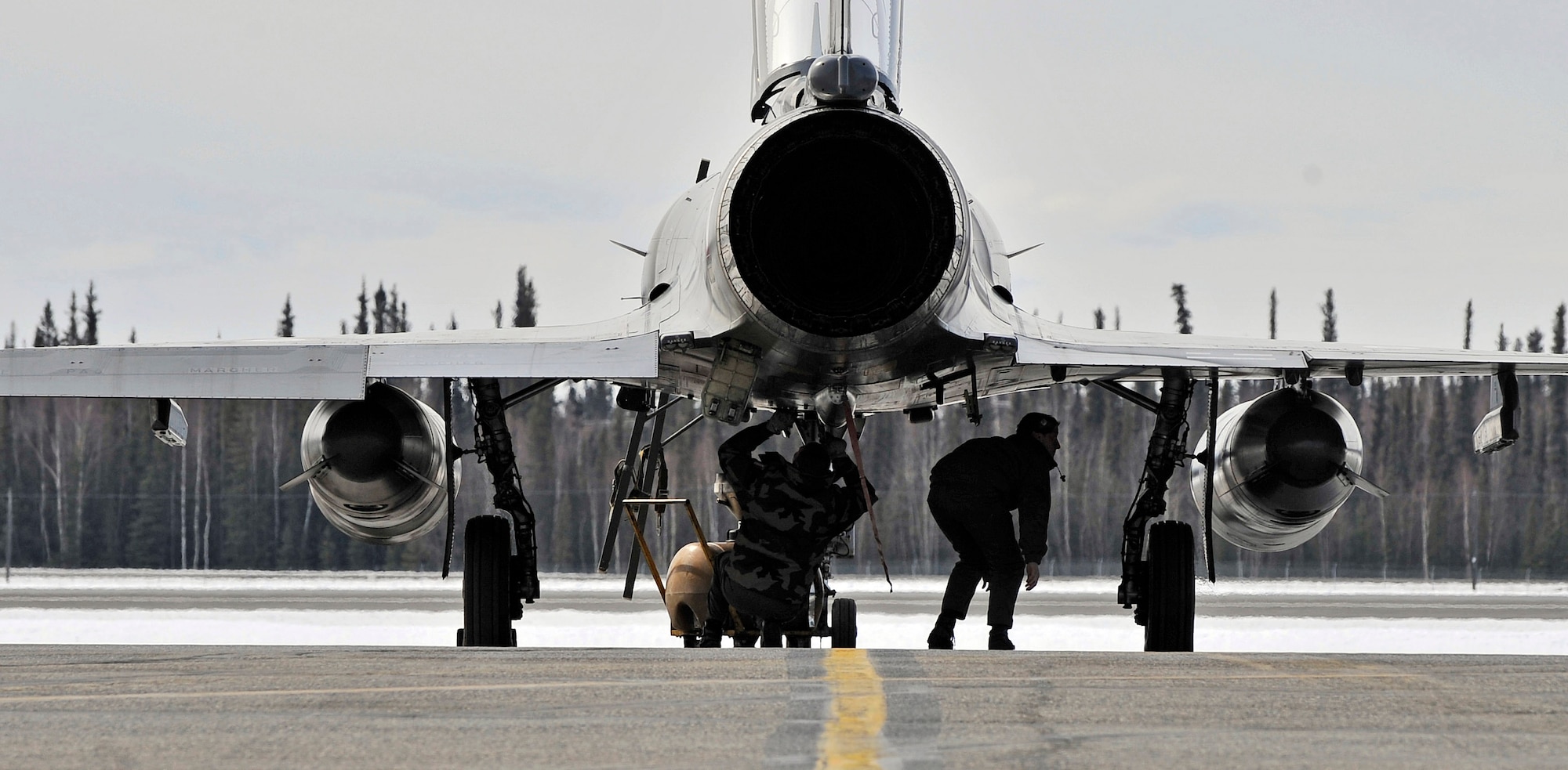 Aircraft maintainers from Luxeuil Air Base, France, conduct post flight checks April 14 on a Mirage 2000 fighter at Eielson Air Force Base, Alaska. French air force personnel arrived at Eielson AFB to participate in Red Flag-Alaska 09-2.  This exercise provides joint offensive counter-air, interdiction, close air support and large-force employment training in a simulated combat environment. (U.S. Air Force photo/Airman 1st Class Willard E. Grande II)
