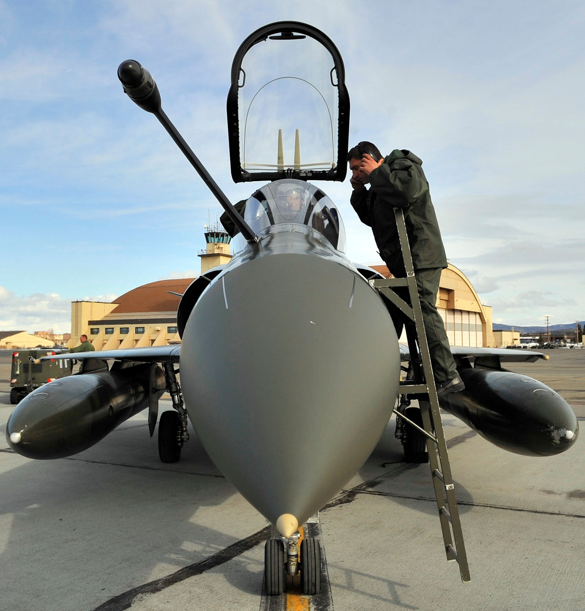 A crew chief from Luxeuil Air Base, France, speaks to a Mirage 2000 pilot April 14 at Eielson Air Force Base, Alaska. French air force personnel arrived at Eielson AFB to participate in Red-Flag Alaska, which provides unique opportunities to integrate various forces into joint, coalition, and bilateral training from simulated forward operating bases. (U.S. Air Force photo/Airman 1st Class Willard E. Grande II)