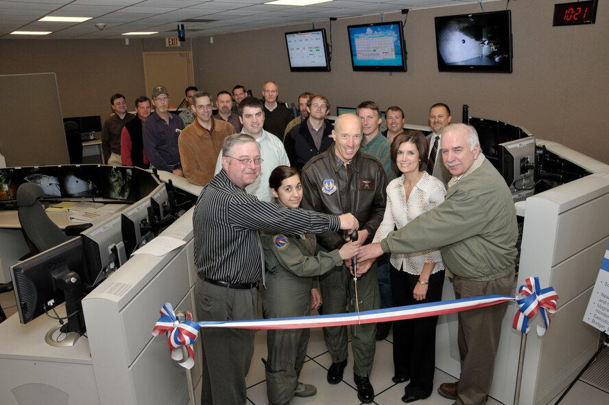 Arnold Engineering Development Center’s (AEDC) 4-foot Transonic Wind Tunnel Control Room has been upgraded into a state-of-the-art test operations center. The operations center is equipped with new audio, video and networked information systems. The renovation, which totaled around a million dollars, allows for increased situational awareness, security upgrades and a better working environment for the operator and the test customer. Pictured from left to right cutting the ribbon is Air Force Project Manager Kemp Brooks, 716th Test Squadron Commander Lt. Col. Vanessa Bond, AEDC Commander Col. Art Huber, Aerospace Testing Alliance (ATA) Project Manager Kim Thompson and Acting ATA Deputy General Manager Steve Pearson. (Photo by Rick Goodfriend)