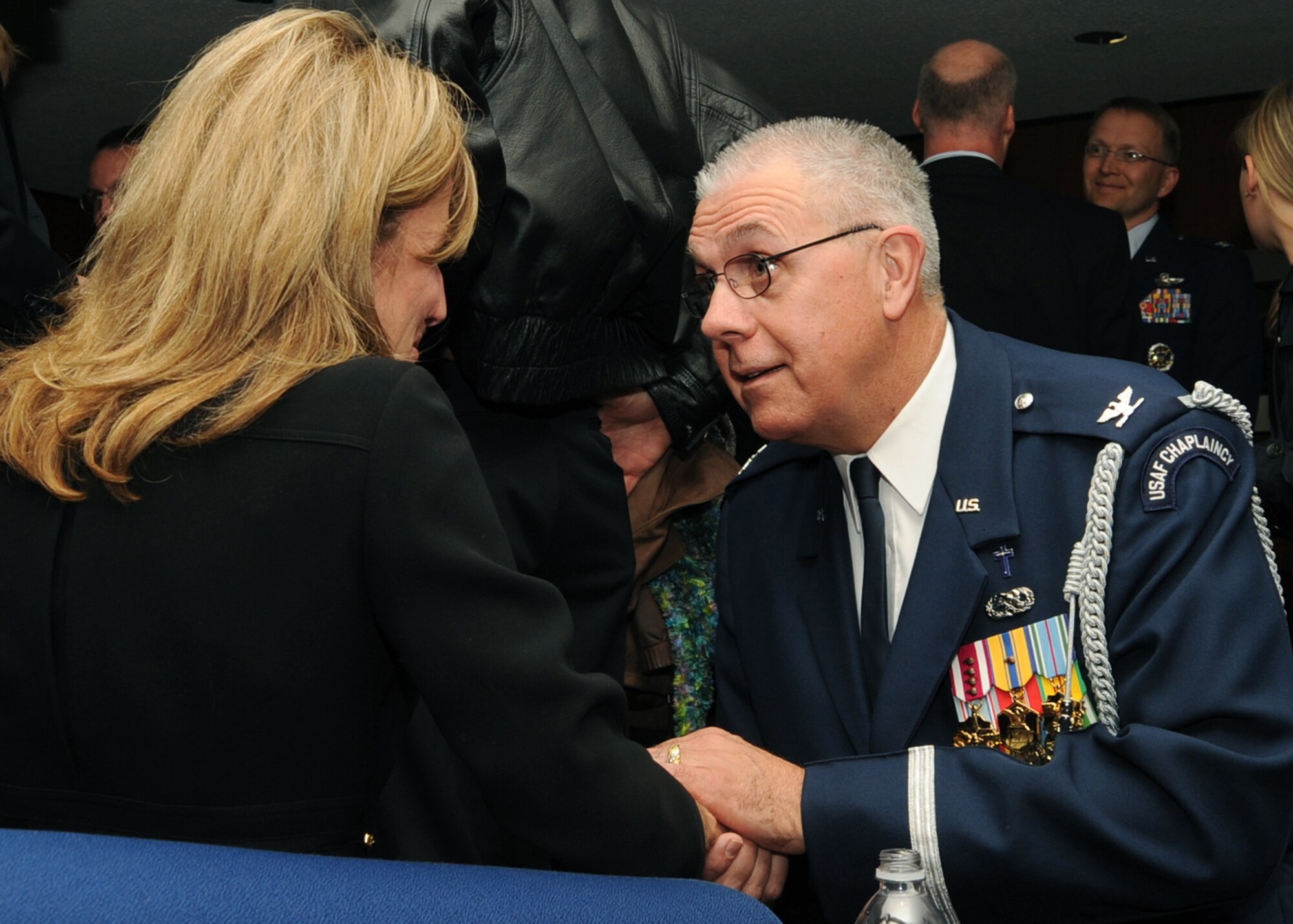 ARLINGTON NATIONAL CEMETERY, Va. -- Chaplain (Col). Charlie Stutts, Senior Chaplain at Arlington National Cemetery, the hand of Lisa Krueger, wife of Col. Michael Krueger, former 22nd Air Refueling Wing vice commander, as people attending the interment gather before the march to the grave site, April 9. (Photo by Airman 1st Class Maria Ruiz)