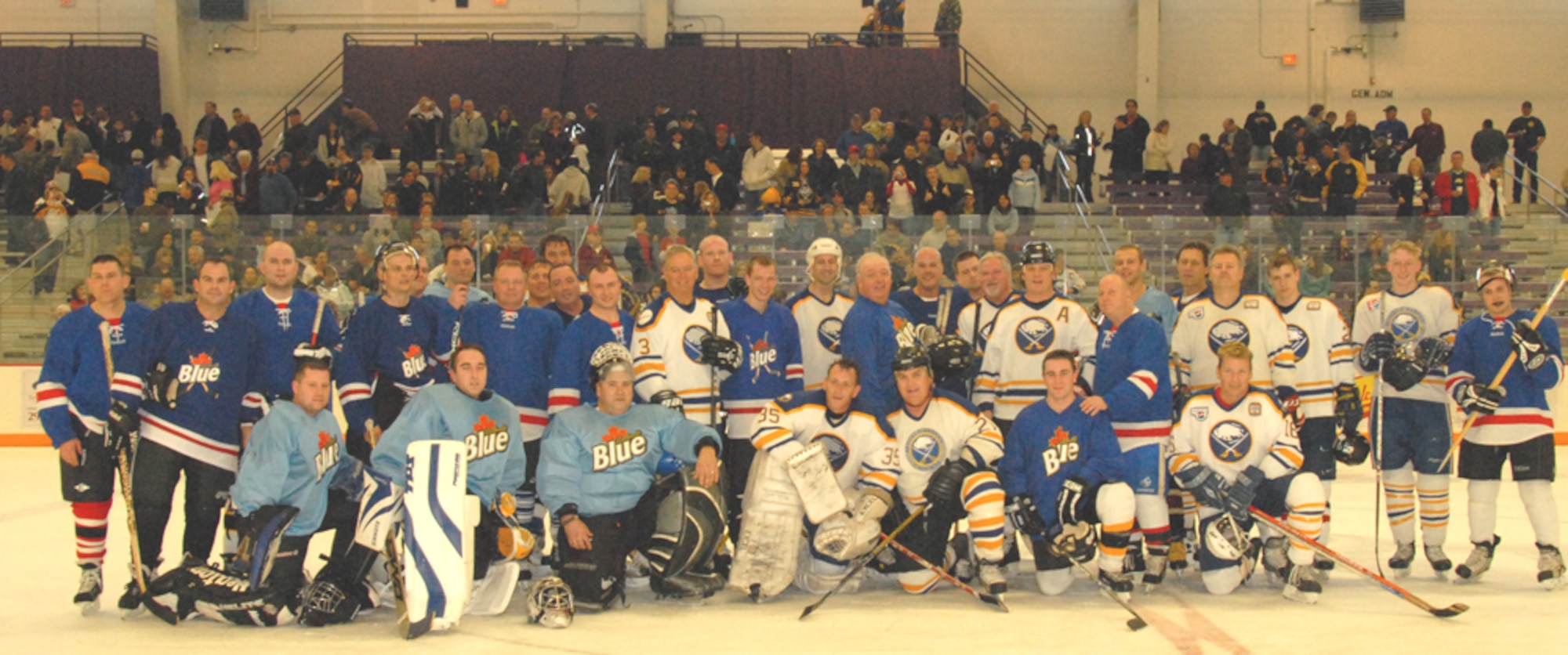 Hockey players from Team Niagara experienced an opportunity that many only dream of. In a fund raising event the Buffalo Sabres Alumni toyed with Team Niagara for two full periods of hard hitting hockey. Above both teams intermingle for a group photo.  (Photo by Tech Sgt. Cathy Perrretta 107th AW)
