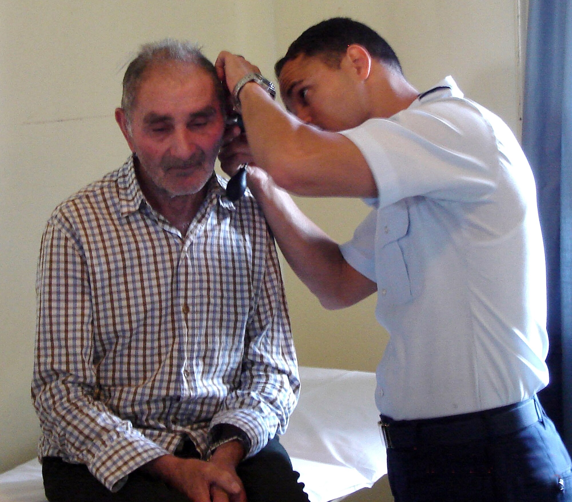 Maj. (Dr.) Jose Barrera; ear, nose and throat physician from Wilford Hall Medical Center; examines a Chilean patient in the otolaryngology clinic at the Chile Chico hospital 24 March.  Major Barrera was part of an 11-man team of Air Force medics from the 59th Medical Wing who participated in a Medical Readiness Training Exercise, or MEDRETE, with 31 Chilean Air Force medics in March 2009. (U.S. Air Force Photo ) 