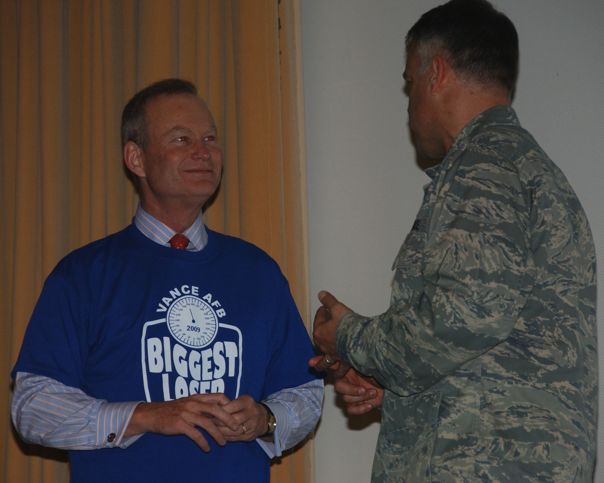 Oklahoma City Mayor Mick Cornett, who started the campaign "This city is going on a diet," visits Vance AFB's own Biggest Loser Competition. Col. Richard Murphy,  71st Flying Training Wing vice commander, presents Mayor Cornett with a Biggest Loser T-Shirt. (U.S. Air Force photo by Staff Sgt. Brian Hill)
