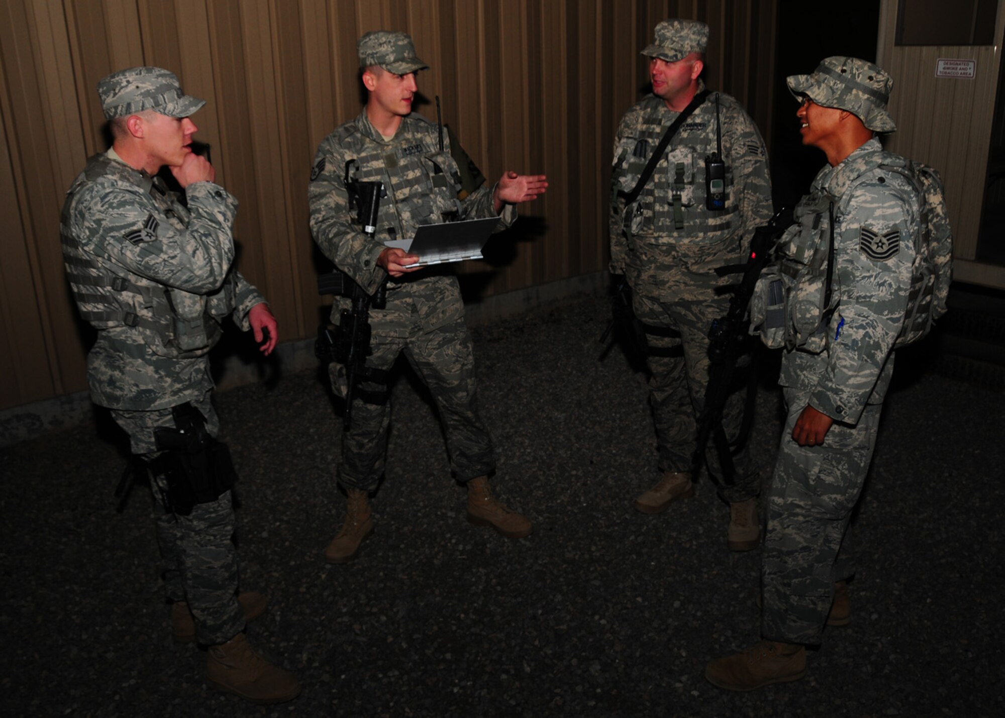 SOUTHWEST ASIA -- Staff Sgt. Nicholas Nickert, 386th Expeditionary Security Forces Squadron security escort team, briefs a mission to other team members after arming up at an air base in Southwest Asia, April 15. The SET is responsible for the safety and security of moving a mass amount of personnel from one destination to another. Sergeant Nickert is currently deployed from Nellis Air Force Base, Nev. and is originally from Grayling, Mich. (U.S. Air Force photo/ Senior Airman Courtney Richardson)