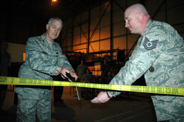 Col. John Probst, 341st Security Forces Group commander, and Tech. Sgt. David Foscue, 341st Secuity Support Squadron NCO in charge of resource logistics, cut the "ribbon" at the official opening of the Engagement Skills Trainer 2000 at building 219 April 14. 
The simulator provides realistic small-arms pre-deployment and recurring training for marksmanship and combat scenarios. The system also provides security forces Airmen with realistic experience in situations where they must decide whether or not to use lethal force in a hostile situation. See the May 15 issue of the Front Range Guardian for more about the EST 2000. (U.S. Air Force photo/Senior Airman Dillon White)
