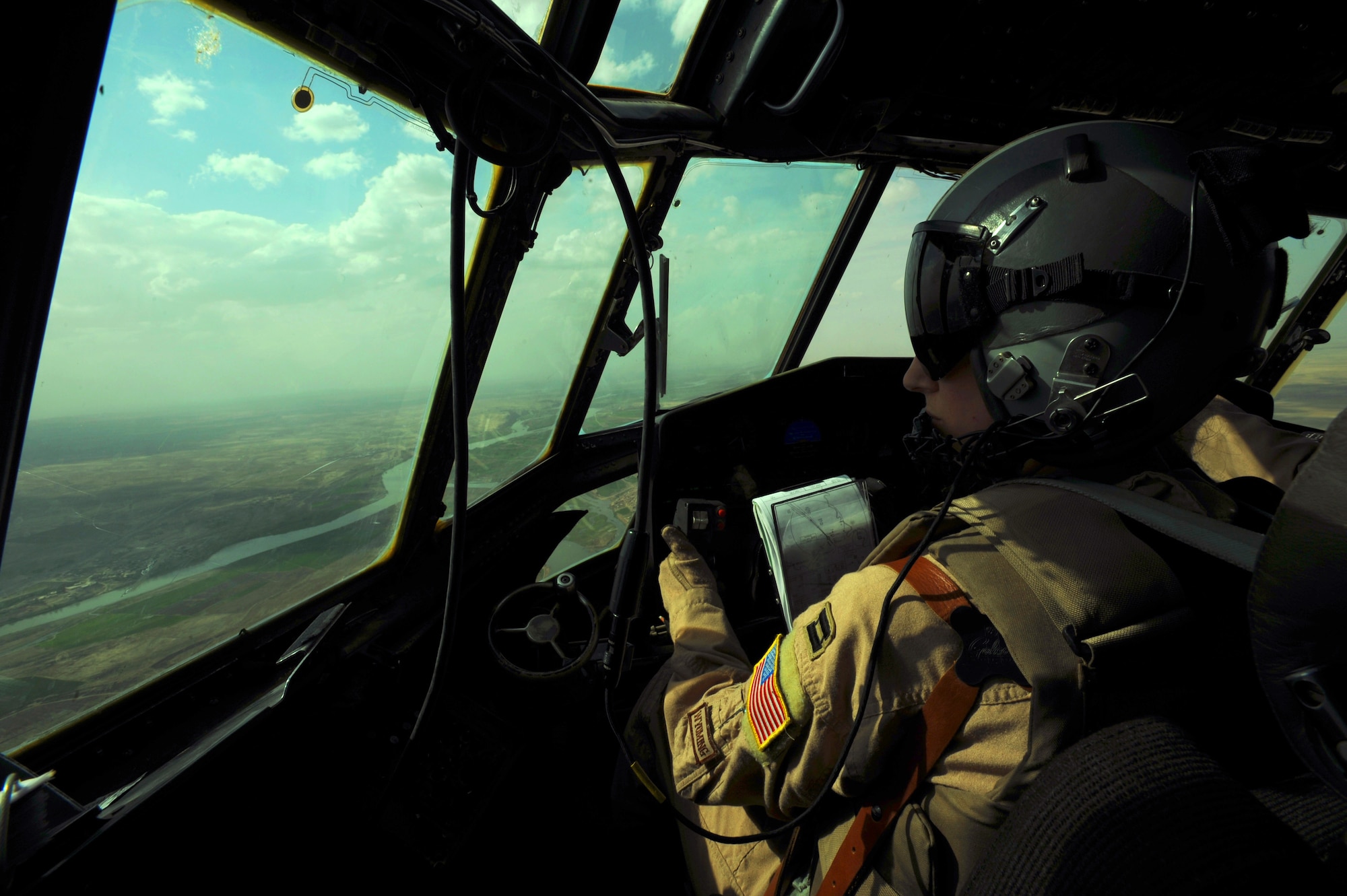 U.S. Air Force Capt. Andrea Judkins, a C-130 Hercules pilot from the 777th Expeditionary Airlift Squadron, Joint Base Balad, Iraq, controls the aircraft during airlift operations April 8, 2009, in support of Operation Iraqi Freedom.  (U.S. Air Force photo by Staff Sgt. James L. Harper Jr.)