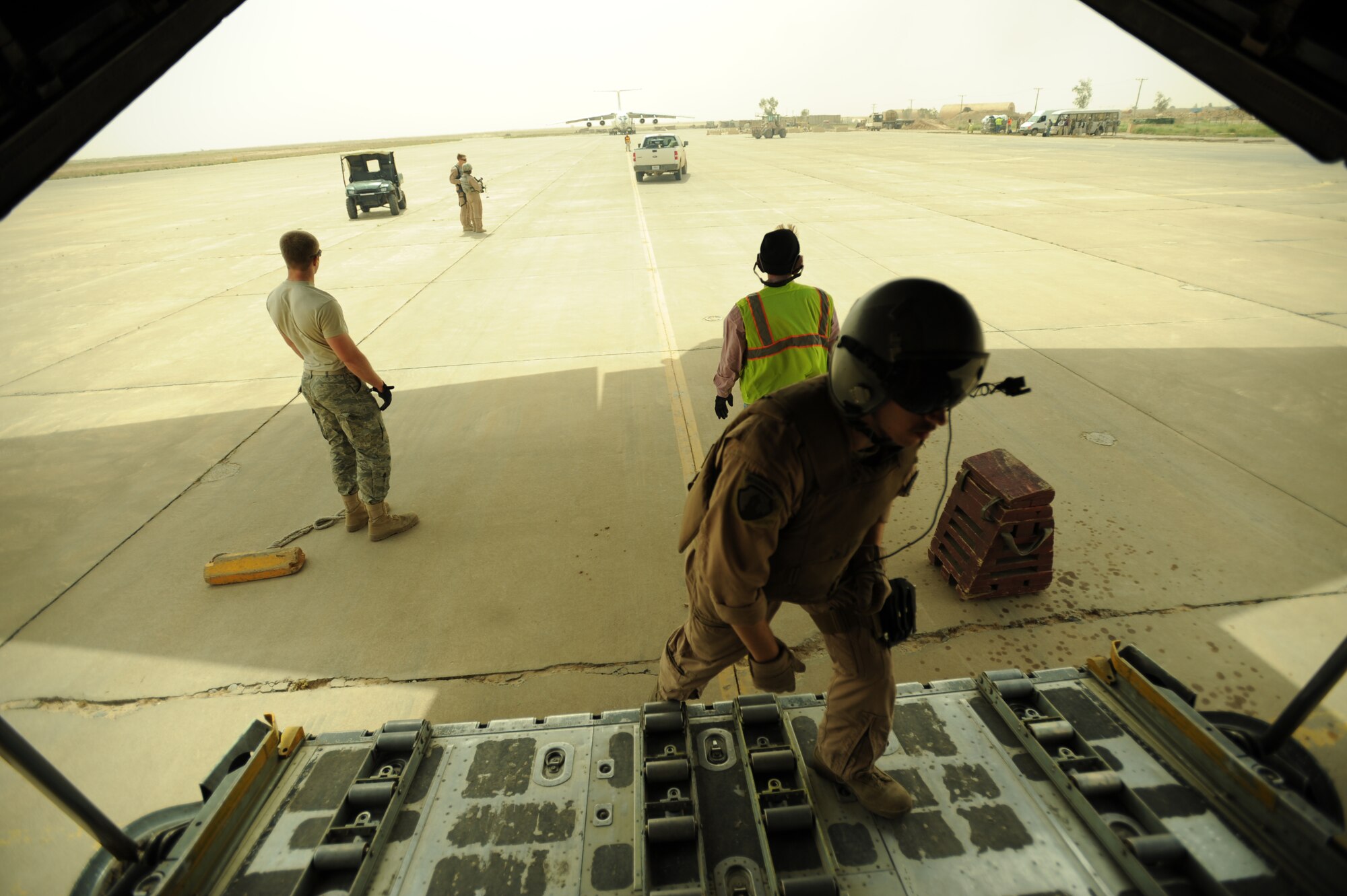 U.S. Air Force C-130 Hercules Loadmaster Airman 1st Class Benjamin Shest, assigned to the 777th Expeditionary Airlift Squadron, Joint Base Balad, Iraq, enters the C-130 during airlift operations April 8, 2009, in support of Operation Iraqi Freedom.  (U.S. Air Force photo by Staff Sgt. James L. Harper Jr.)