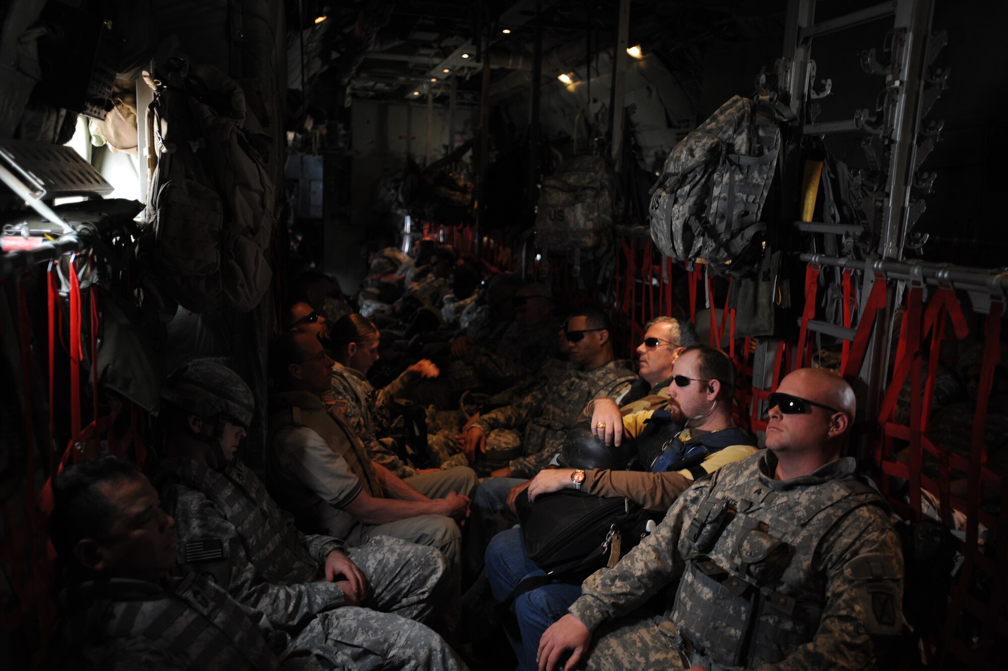 Passengers sit aboard a U.S. Air Force C-130 from the the 777th Expeditionary Airlift Squadron, Joint Base Balad, Iraq, during airlift operations April 8, 2009, in support of Operation Iraqi Freedom.  (U.S. Air Force photo by Staff Sgt. James L. Harper Jr.)