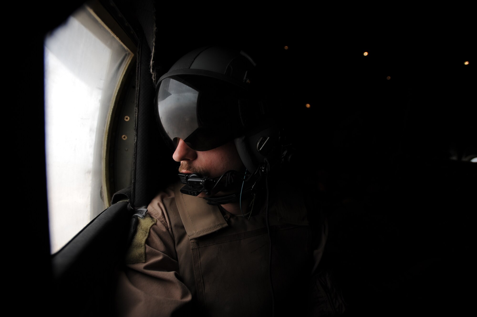 U.S. Air Force C-130 Hercules Loadmaster Airman 1st Class Benjamin Shest, assigned to the 777th Expeditionary Airlift Squadron, Joint Base Balad, Iraq, scans for threats after take off during airlift operations April 8, 2009, in support of Operation Iraqi Freedom.  (U.S. Air Force photo by Staff Sgt. James L. Harper Jr.)