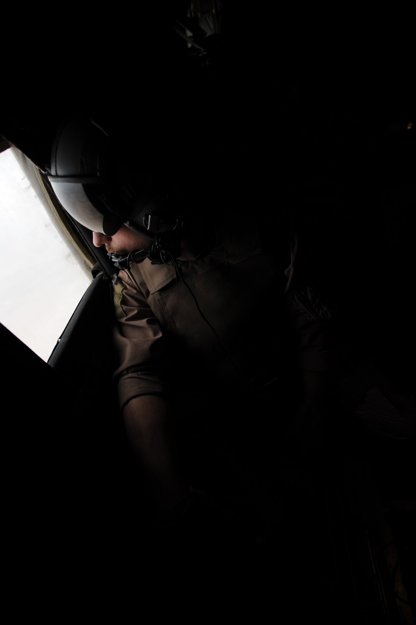 U.S. Air Force C-130 Hercules Loadmaster Airman 1st Class Benjamin Shest, assigned to the 777th Expeditionary Airlift Squadron, Joint Base Balad, Iraq, scans for threats after take off during airlift operations April 8, 2009, in support of Operation Iraqi Freedom.  (U.S. Air Force photo by Staff Sgt. James L. Harper Jr.)