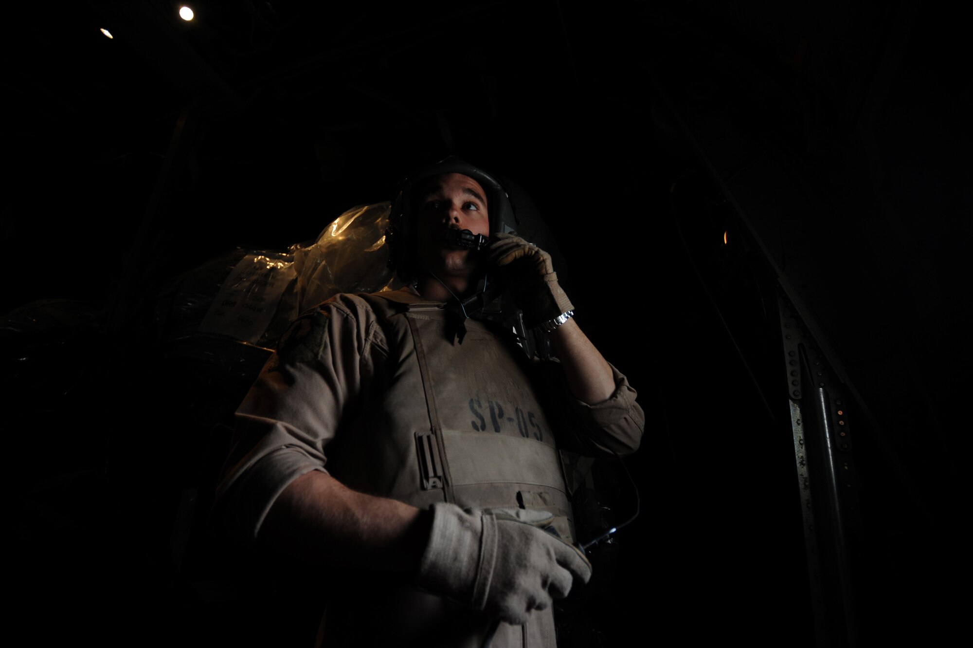 U.S. Air Force C-130 Hercules Loadmaster Airman 1st Class Benjamin Shest, assigned to the 777th Expeditionary Airlift Squadron, Joint Base Balad, Iraq, conducts a communications checkprior to take off during airlift operations April 8, 2009, in support of Operation Iraqi Freedom.  (U.S. Air Force photo by Staff Sgt. James L. Harper Jr.)