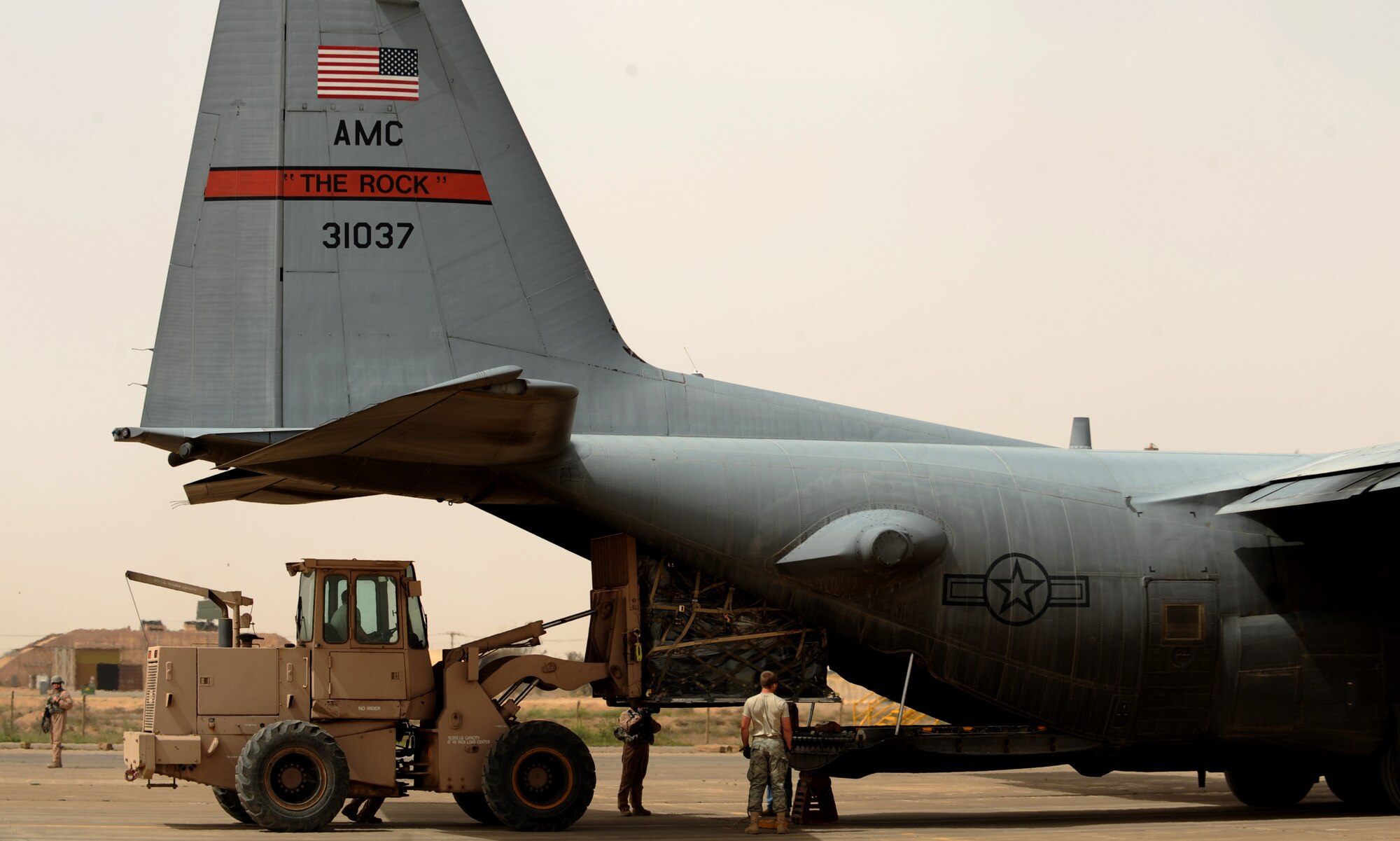 A U.S. Air Force C-130 Hercules, assigned to the 777th Expeditionary Airlift Squadron, Joint Base Balad, Iraq, receives cargo during airlift operations April 8, 2009, in support of Operation Iraqi Freedom.  (U.S. Air Force photo by Staff Sgt. James L. Harper Jr.)