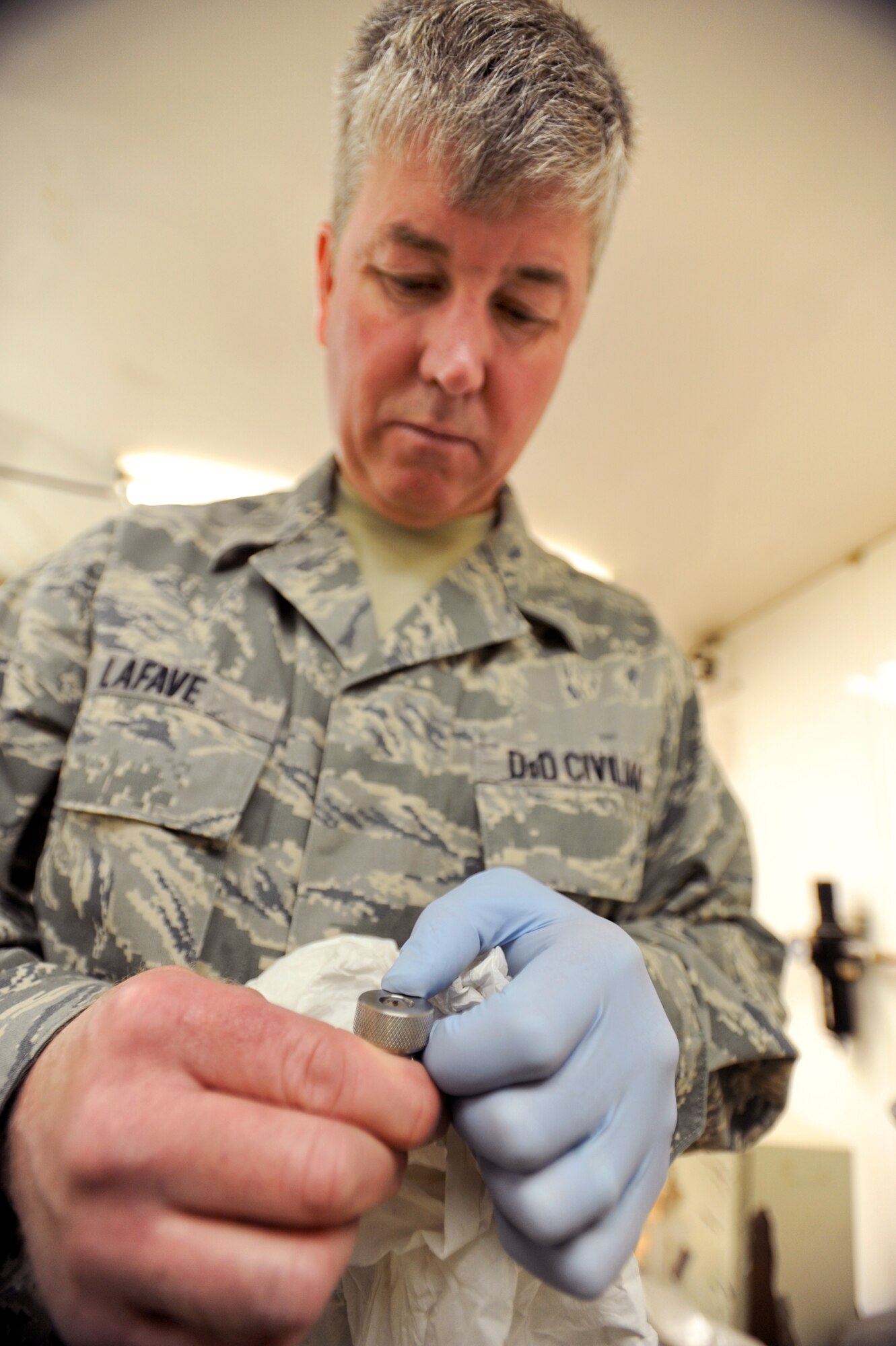 James Lafave, a civilian quality assurance specialist with the 379th Expeditionary Logistic Readiness Squadron, checks a bearing for markings after a fuels lubricity test, April 14, 2009, in an undisclosed location in Southwest Asia.  Mr. Lafave receives samples of fuel from different locations around the U.S. Central Command's area of responsibility for testing to ensure the fuels are meeting Air Force standards.  Mr. Lafave is native to Helena, Mont. and is deployed from Wright-Patterson Air Force Base, Ohio, in support of Operations Iraqi and Enduring Freedom and Combined Joint Task Force - Horn of Africa.  (U.S. Air Force Photo by Staff Sgt. Joshua Garcia/released)