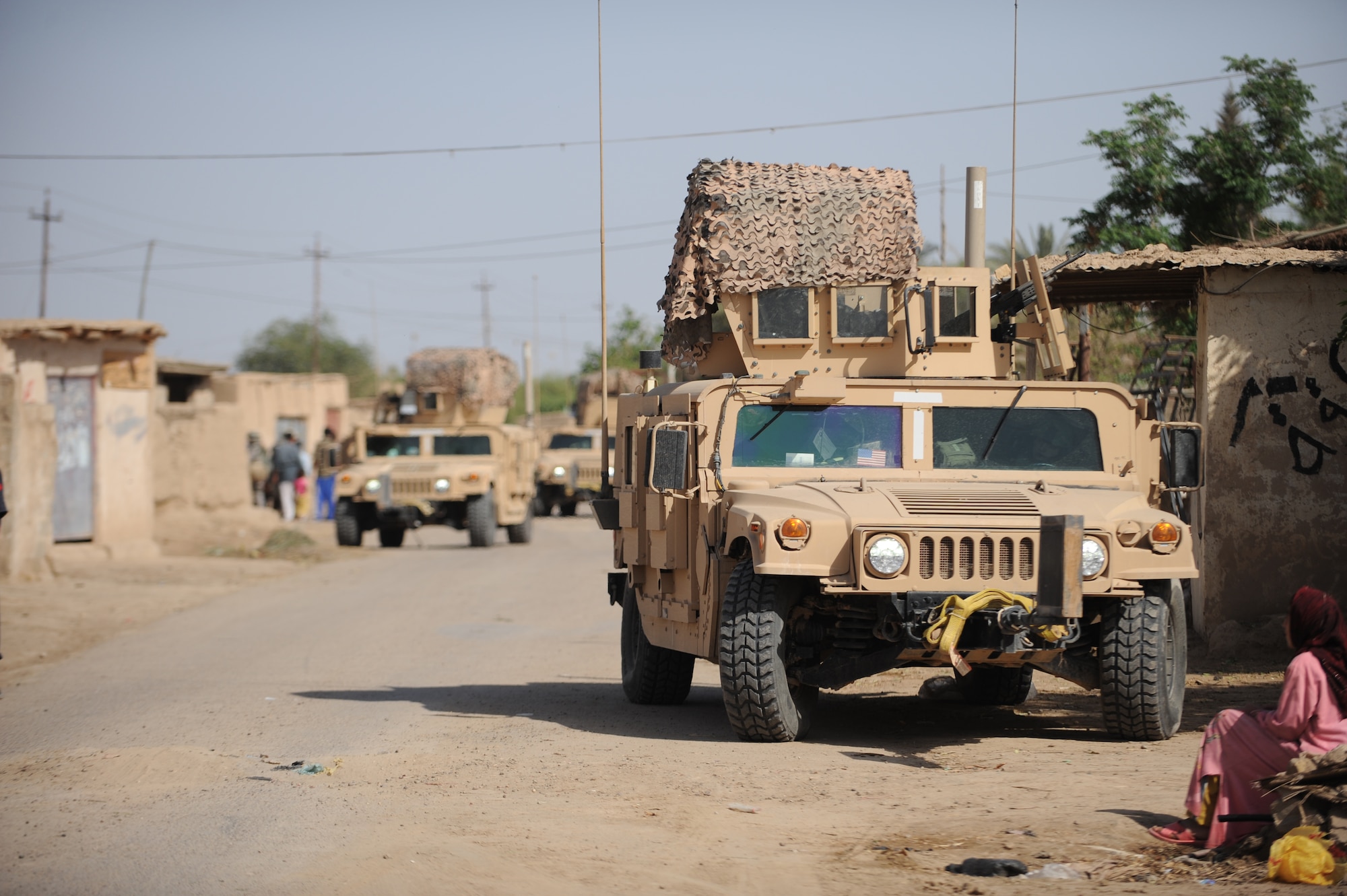 Humvee's from the 532nd Expeditionary Security Forces Squadron, Joint Base Balad, Iraq, conduct security during a patrol in the village of Abo Atei April 9, 2009, in support of Operation Iraqi Freedom.  (U.S. Air Force photo by Staff Sgt. James L. Harper Jr.)
