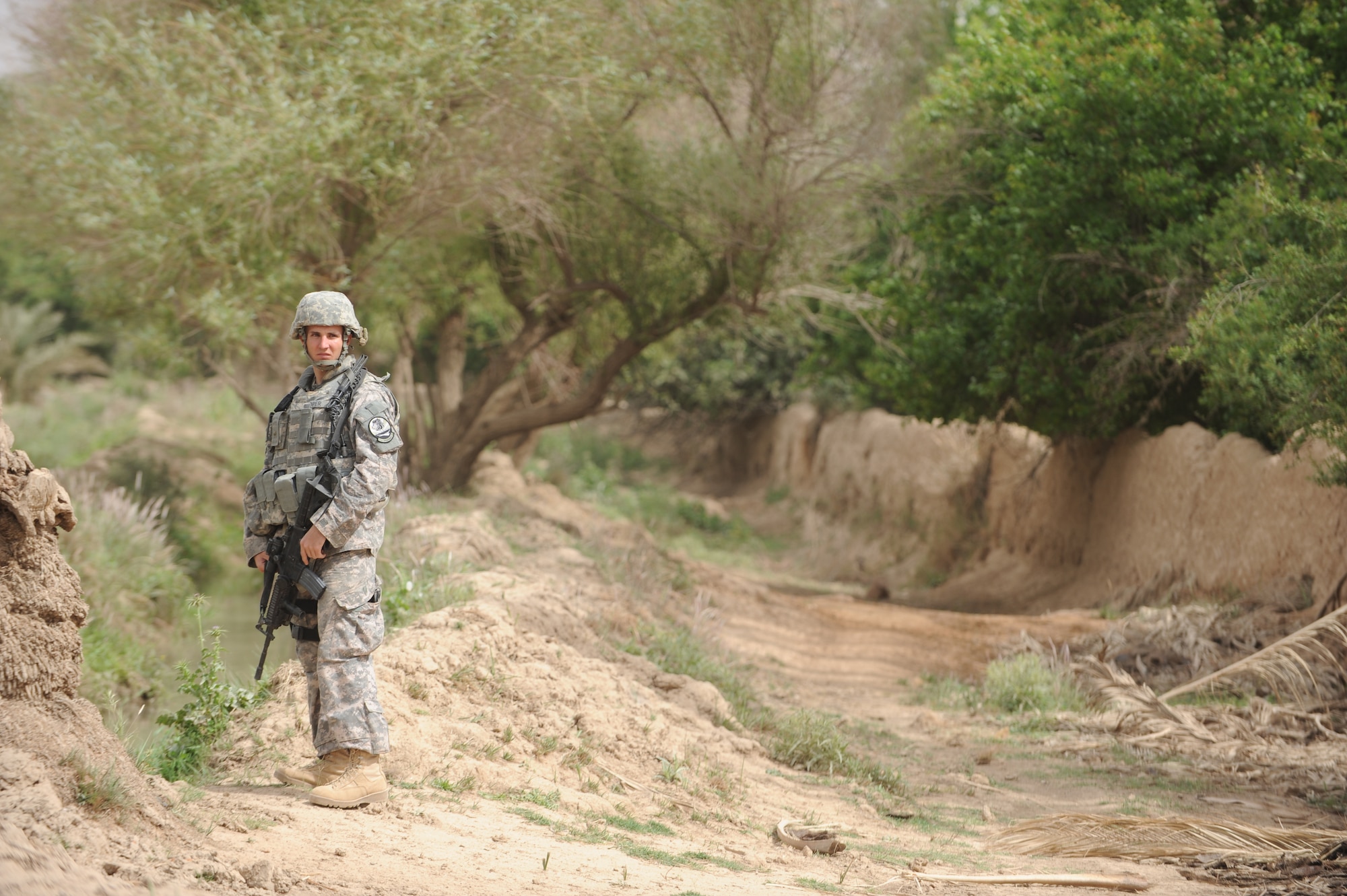 U.S. Air Force Airman 1st Class Daniel Cooper, 532nd Security Forces Squadron, Joint Base Balad, Iraq, conducts security during a patrol in Bakr village, Iraq, April 9, 2009, in support of Operation Iraqi Freedom.  (U.S. Air Force photo by Staff Sgt. James L. Harper Jr.)