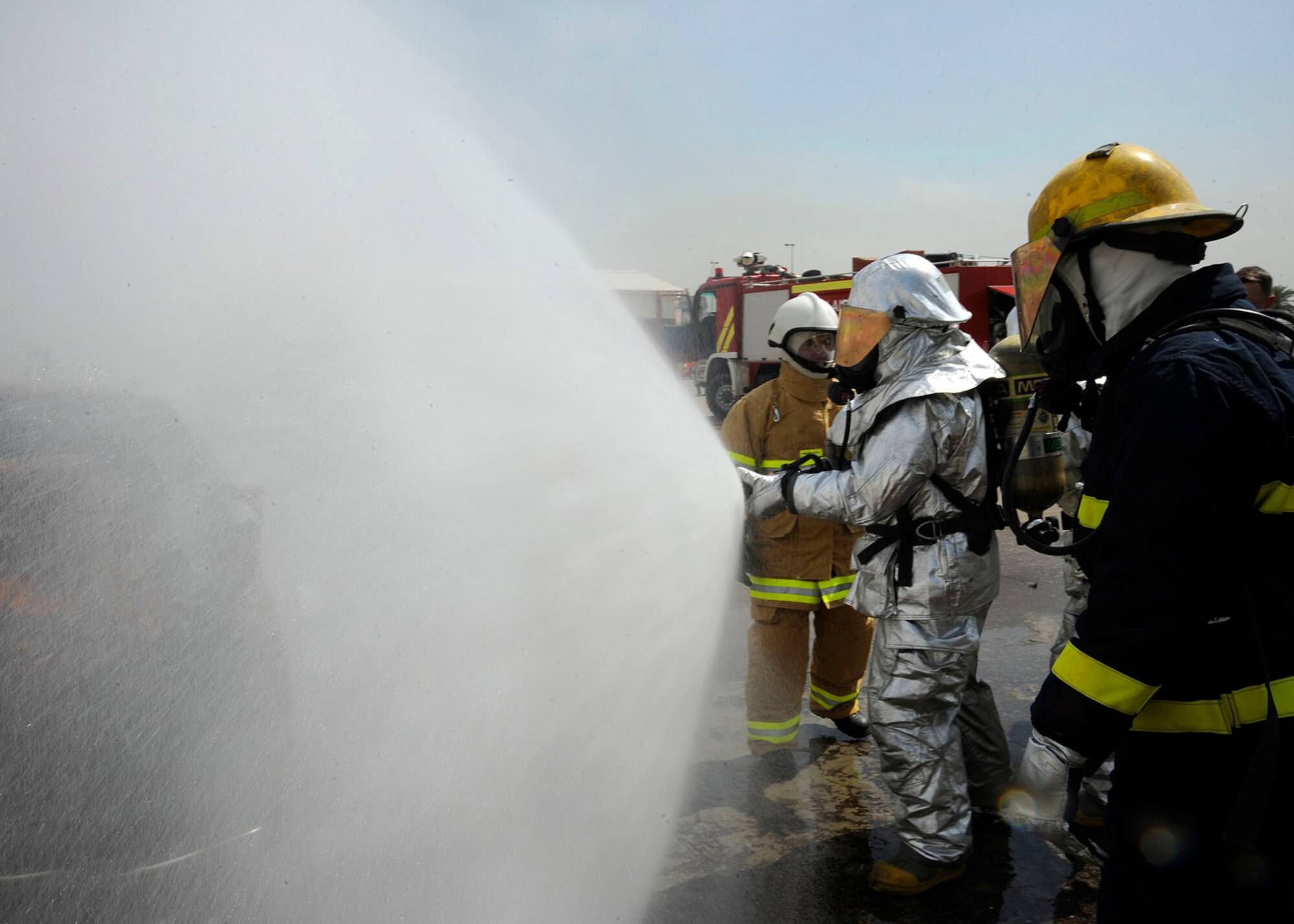 Tech. Sgt. Jay Wingfield (right), 821st Basic Technical Training Squadron Coalition Air Force Transition  Team fire rescue advisor, asses the trainees of the Basic Fire Course in Baghdad, Iraq April 11, 2009. Sergeant Wingfield is advising members of the Iraqi air force and Iraqi civil defense on their techniques during a live-burn exercise at the Iraqi Joint Fire Academy.  26 students will become fire fighters after the completion of the two-month course. Sergeant Wingfield is deployed from Goodfellow Air Force Base, Texas and is a native of Peoria, Ill.  (U.S. Air Force photo by Senior Airman Jacqueline Romero)