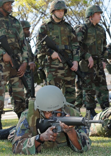 YOKOTA AIR BASE, Japan -- Chief Master Sgt. Jacob Dunbar, 374th Civil Engineer Squadron, assumes the prone position April 15 during a three-day combat skills training course. Contractors from Analytical Services, Inc., provided the pre-deployment training to members of Team Yokota. (U.S. Air Force photo/Senior Airman Veronica Pierce)

