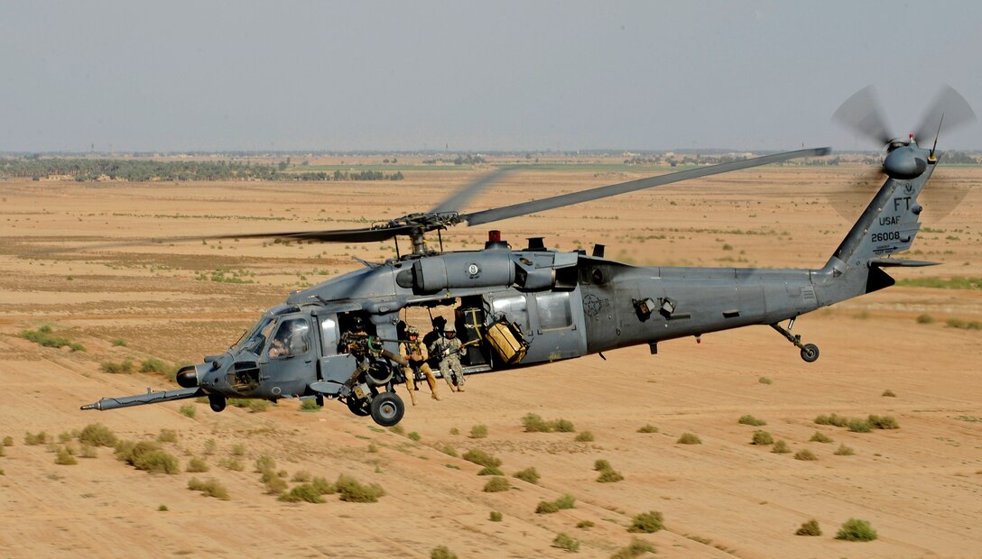 A U.S. Air Force HH-60 Pave Hawk helicopter carrying pararescuemen flies over the Iraqi landscape during a proficiency exercise outside Joint Base Balad, Iraq, April 10, 2009. The crew and airmen are assigned to the 64th Expeditionary Rescue Squadron.