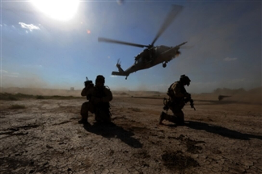 U.S. Air Force pararescuemen assigned to the 64th Expeditionary Rescue Squadron, Joint Base Balad, Iraq, prepare to board an HH-60 Pave Hawk helicopter during proficiency training outside Baghdad, Iraq, on April 10, 2009.  