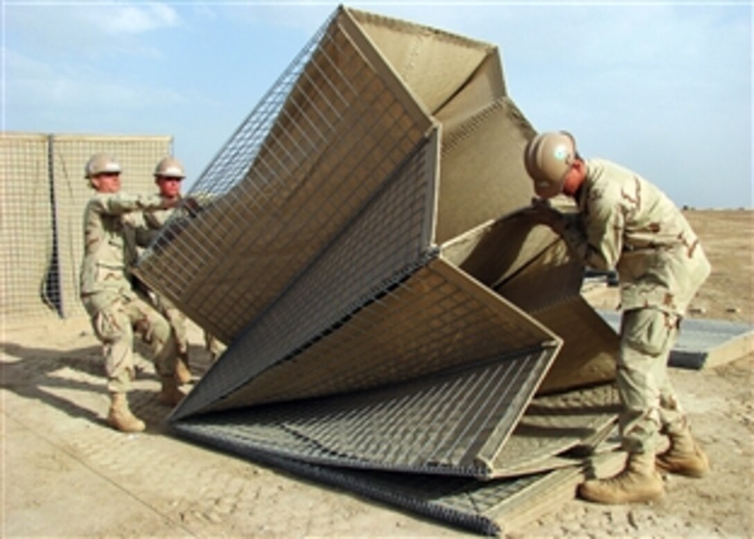 U.S. Navy sailors assigned to Naval Mobile Construction Battalion 5 lift a collapsible wire mesh gabion into position on Camp Bastion, Afghanistan, April 11, 2009. The battalion is deployed to Afghanistan to provide contingency construction support to allies and members of the NATO International Security Assistance Force.