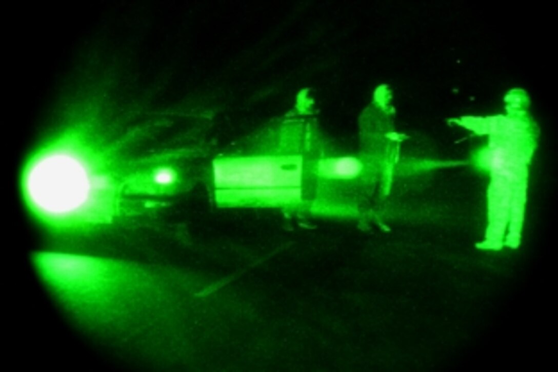 As seen through a night-viewing device, a U.S. Army soldier  stops a vehicle during a joint patrol in Bagram, Afghanistan, April 15, 2009. The soldier is assigned to the 101st Airborne Division's Company A, Personnel Security Detail. 