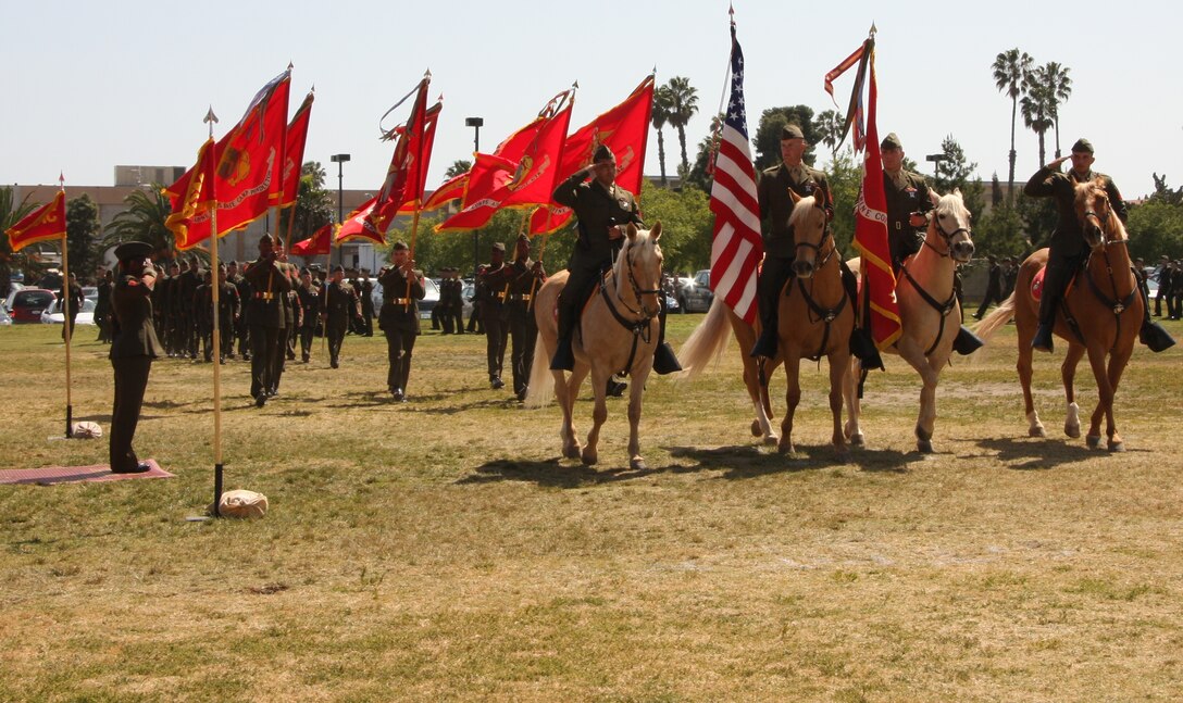 Now retired, Sgt. Maj. Barbara J. Titus salutes the Marine Corps' last mounted colorguard during the pass in review portion of Marine Corps Installation West's sergeant major appointment and releif ceremony April 16. Titus relenquished her post to Sgt. Maj. Jeffery H. Dixon who will now advise Maj. Gen. Michael G. Lehnert, commanding officer, MCIWEST, in  installation management.