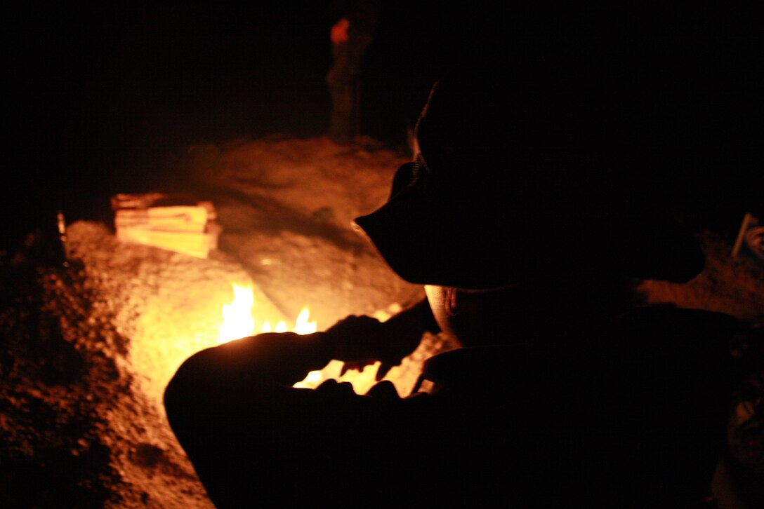 Lance Cpl. Aaron Kristopik, a paralegal clerk with the Combat Center’s Staff Judge Advocate and a native of New Britain, Conn., kicks back by a camp fire April 18 when he traveled to the Mojave National Preserve to get away from civilization.