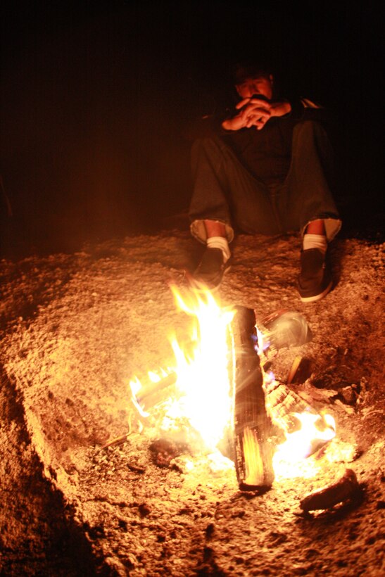 Lance Cpl. Aaron Kristopik, a paralegal clerk with the Combat Center’s Staff Judge Advocate and a native of New Britain, Conn., enjoys a fire he has freshly stoked. Kristopik took an adventure out into the wild on April 18 to get away from the stress of everyday life.