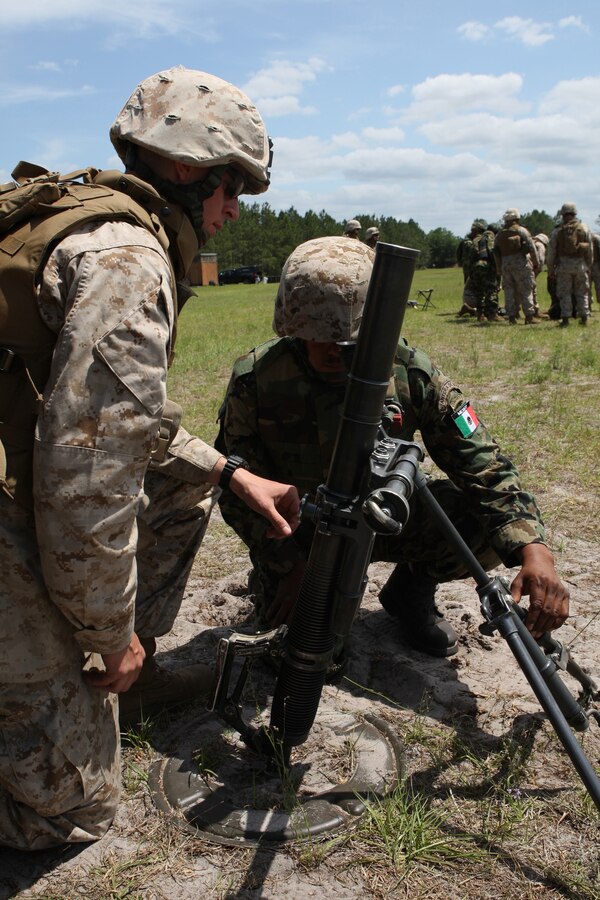 A U.S. Marine instructs a Marine from Mexico's Battango-2, Amphibious Command Battalion on the M224 60mm Lightweight Mortar during Partnership of the Americas 2009.  During POA, U.S. Marines deployed as Special Purpose Marine Air Ground Task Force 24 (SPMAGTF 24), comprised of Marines from the II Marine Expeditionary Force, Marine Medium Helicopter Squadron 764 (HMM-764), 4th Marine Logistics Group and the 24th Marine Regiment., will train with partner nation Marines from Brazil, Chile, Colombia, Mexico, Peru, Uruguay, and soldiers from the Canadian Royal Army.  POA, which is being executed simultaneously with UNITAS Gold, is an annual U.S. Marine Corps Forces, South multi-national company-level combined and joint exercise that focuses on enhancing interoperability between U.S. Marines and partner-nation Marines in the areas of amphibious operations, non-combatant evacuation operations (NEO), peacekeeping and disaster relief. "This year's goals are to build capabilities to operate with partner-nations naval forces aboard and off amphibious ships and to enhance USMC and partner-nation NEO interoperability for potential regional natural disaster or relief operations," said Col. Augustin Bolanio, POA 09 exercise director. In all more than 25 ships, 50 rotary and fixed wing aircraft, 650 Marines, 6500 Sailors and four submarines will participate in exercises POA and UNITAS Gold.  UNITAS Gold, a multiservice and multinational exercise is the oldest combined exercise within the Department of Defense.