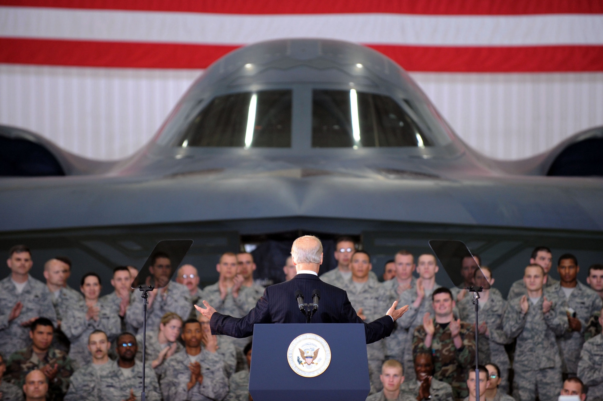 With a B-2 Spirit bomber in the background, Vice President Joe Biden speaks to the troops at Whiteman Air Force Base, Mo., April 16 to show the administration's support for the troops. Mr. Biden later visited Jefferson City and the University of Missouri-St. Louis to highlight progress of the Recovery Act. (U.S. Air Force photo/Senior Airman Jason Huddleston) 
