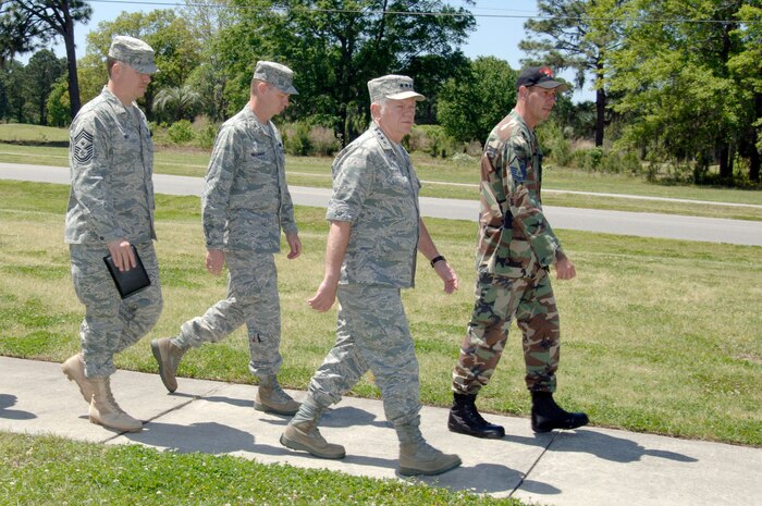 Col. John "Red" Millander and Chief Master Sgt. Mike Ivey follow as Master Sgt. Joseph Mulder takes Gen. Arthur Lichte on a tour of the Airmen's dormitory and center during his visit here April 16. General Lichte stopped at Charleston AFB for a morale visit on his way to Columbia, S.C., to attend the Doolittle Raiders Reunion. General Lichte is the commander of Air Mobility Command, Scott AFB, Ill. Colonel Millander is the 437th Airlift Wing commander and Chief Ivey is the 437th Airlift Wing command chief. Sergeant Mulder is assigned to the 437th Civil Engineer Squadron. (U.S. Air Force photo/Staff Sgt. Marie Cassetty)