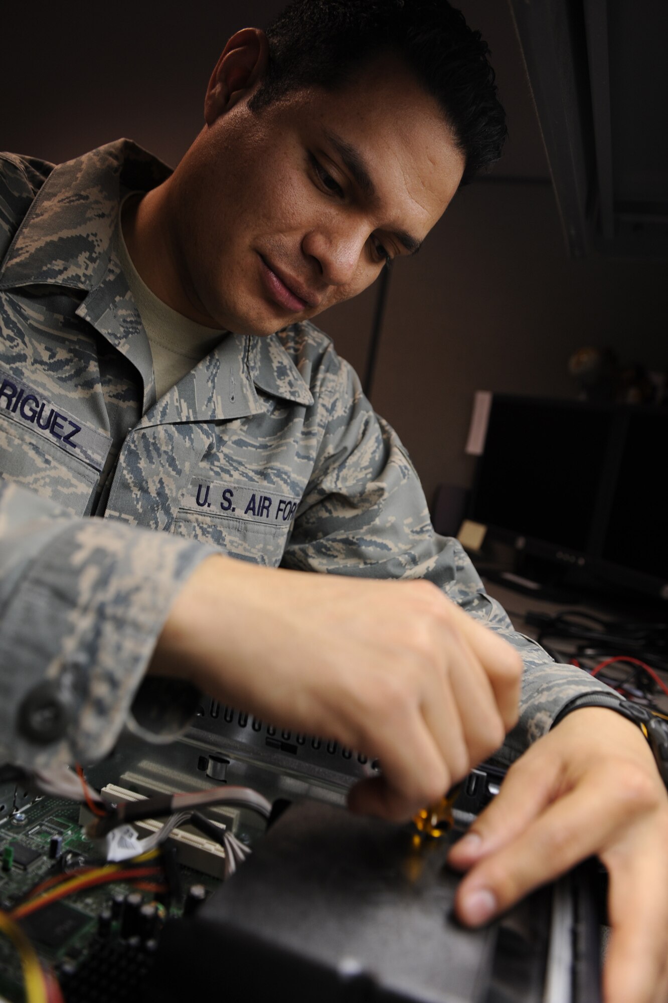 Senior Airman Santos Rodriguez, 28th Mission Support Group client system administrator, repairs and troubleshoots a computer here, April 16. Airman Rodriguez troubleshoots 35 to 40 computers per week, saving the Air Force thousands of dollars. If Ellsworth purchased new machines instead of having specialists repair them, it would cost about $18,000 in new computers. (U.S. Air Force photo/Airman 1st Class Joshua J. Seybert)