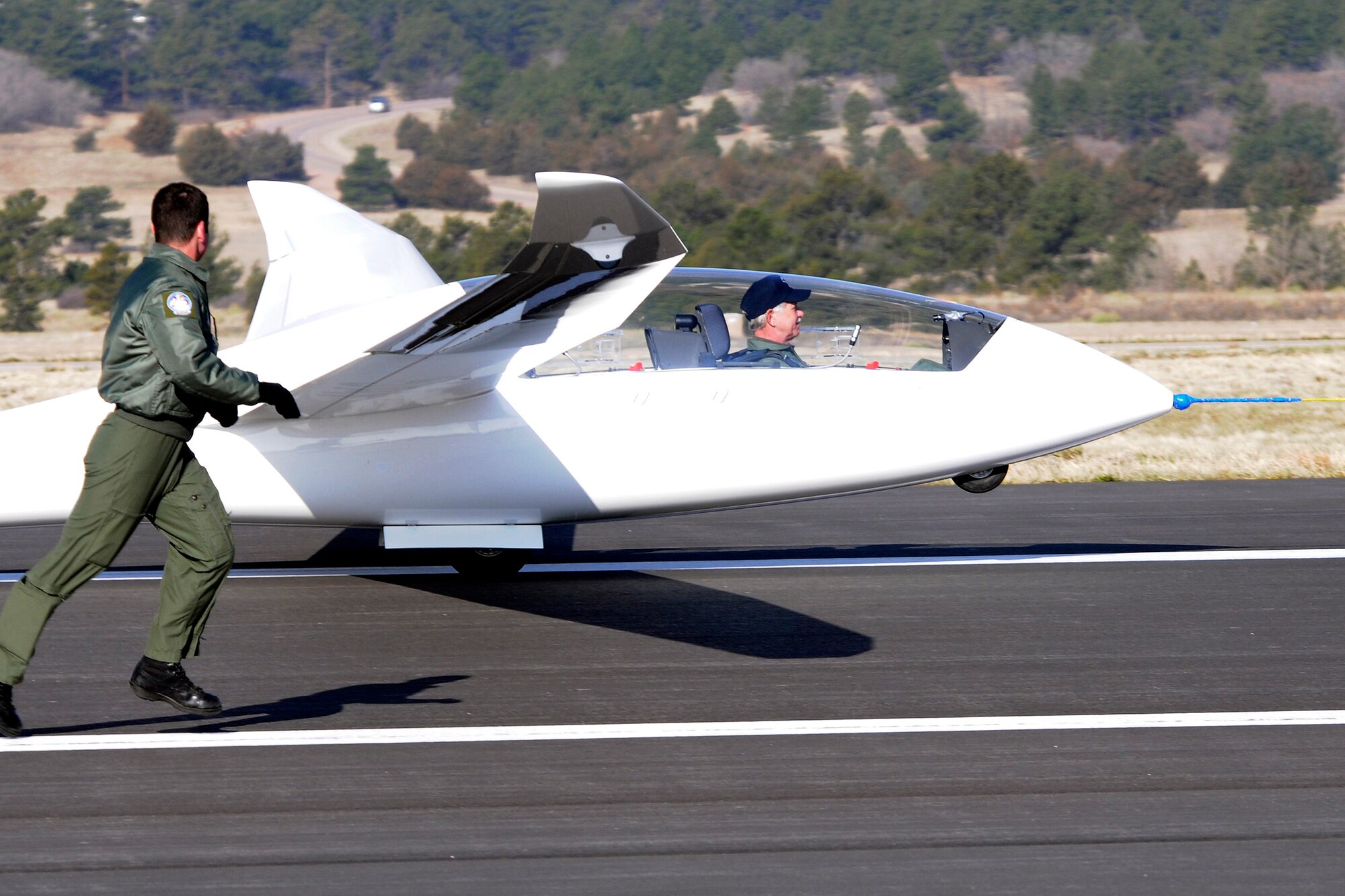 Chesley "Sully" Sullenberger, recipient of the 2009 Col. James Jabara Award for Airmanship, receives a 30-minute glider ride on April 16 from instructor pilot Cadet 1st Class Joseph Baldwin. Stabilizing the glider on take off is Cadet 2nd Class Madison Burgess. (U.S. Air Force photo/Dave Ahlschwede)