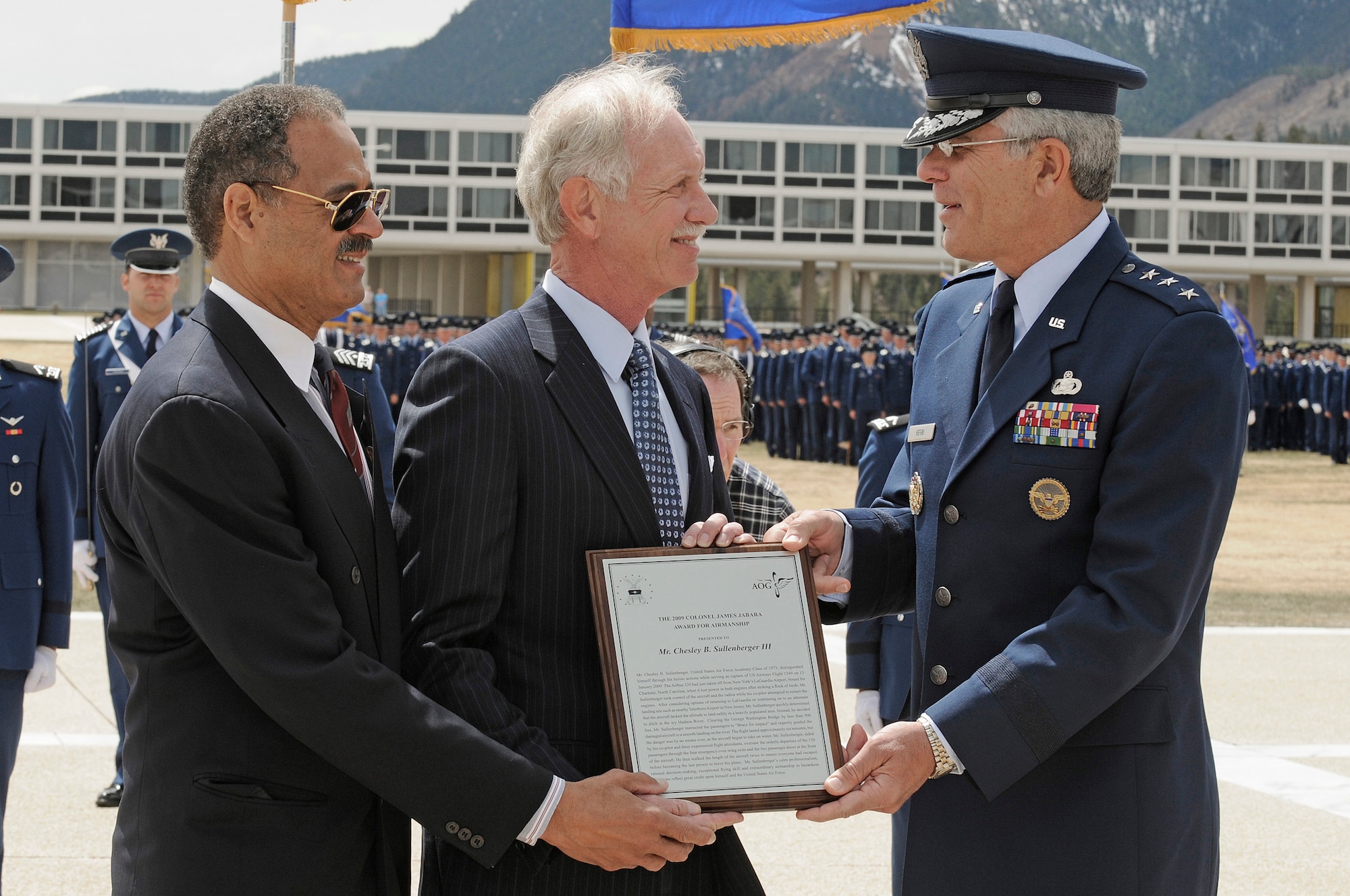 Air Force Academy Superintendent Lt. Gen. John F. Regni presents the 2009 Col. James Jabara award to 1973 graduate and classmate Chesley "Sully" Sullenberger during a parade held in his honor April 15. Assisting is William "T" Thompson, chief executive officer for the Association of Graduates. Capt. Sullenberger received the award for displaying extraordinary Airmanship in hazardous conditions by landing the crippled U.S. Airways Flight 1549 in the Hudson River Jan. 15. (U.S. Air Force photo/ Mike Kaplan) 