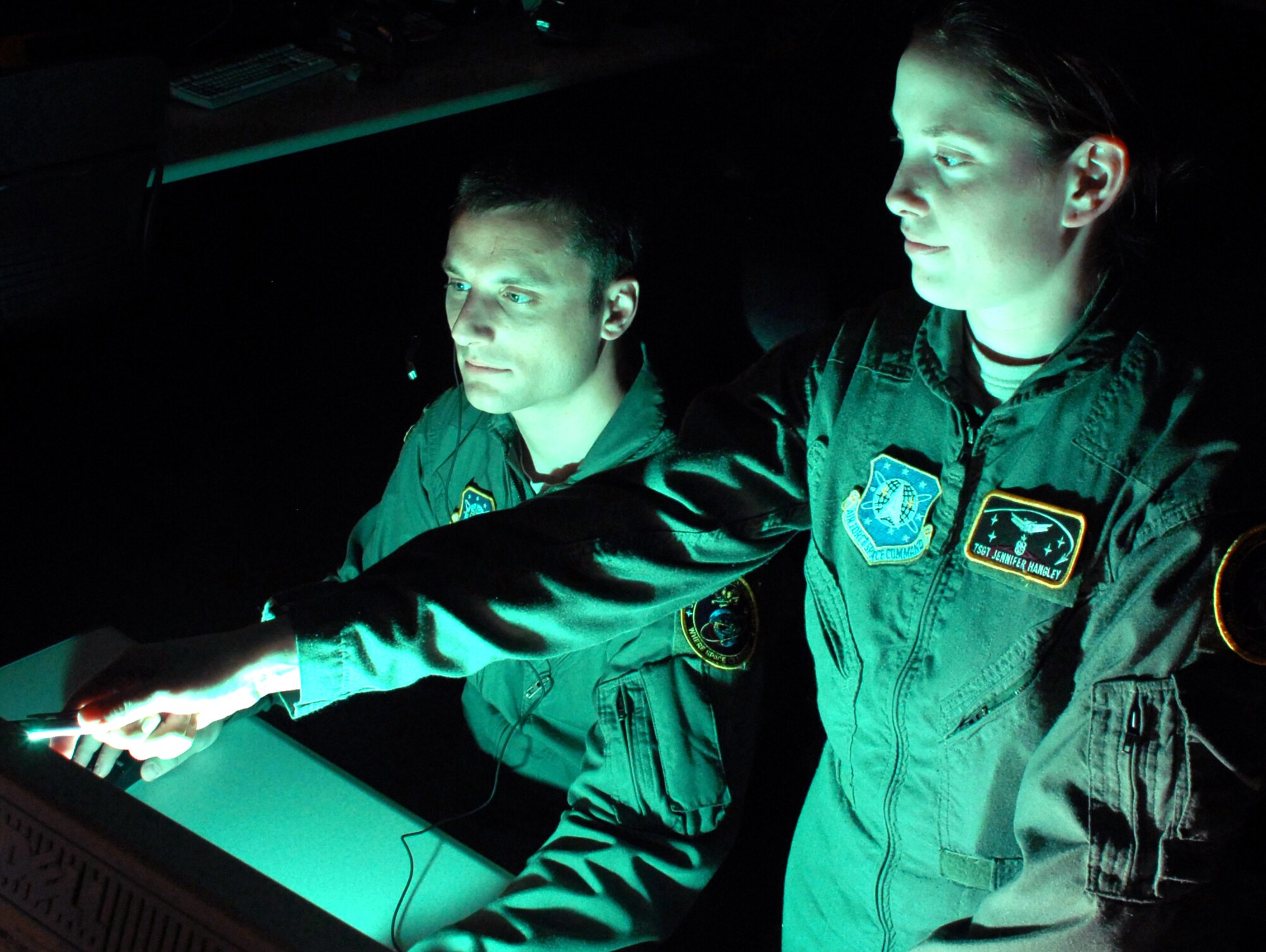 Tech. Sgt. Gavin Iteen (left) and Tech. Sgt. Jennifer Hangley, missile warning duty officers at the Joint Space Operations Center at Vandenberg Air Force Base, Calif., review data received from the Delta II site there. The purpose of the JSpOC is to provide a focal point for the operational employment of worldwide joint space forces, and enable the commander of Joint Functional Component Command Space to integrate space power into global military operations.  (U.S. Air Force photo/Airman 1st Class Antoinette Lyons) 