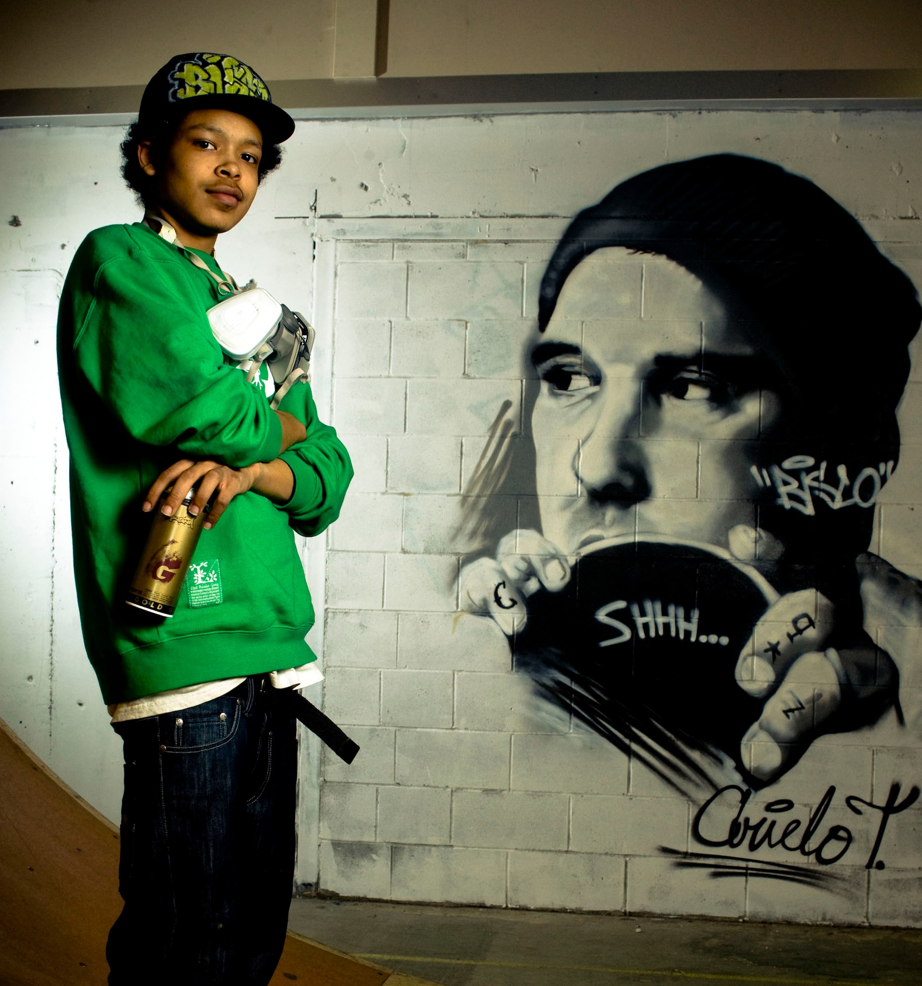 Arielo Taylor stands in front of his work at the skate park inside the base community center April 3 at Elmendorf Air Force Base, Alaska. Mr. Taylor helped Staff Sgt. Art Delafuente decorate the skate park with graffiti. (U.S. Air Force photo/Senior Airman Jonathan Steffen)