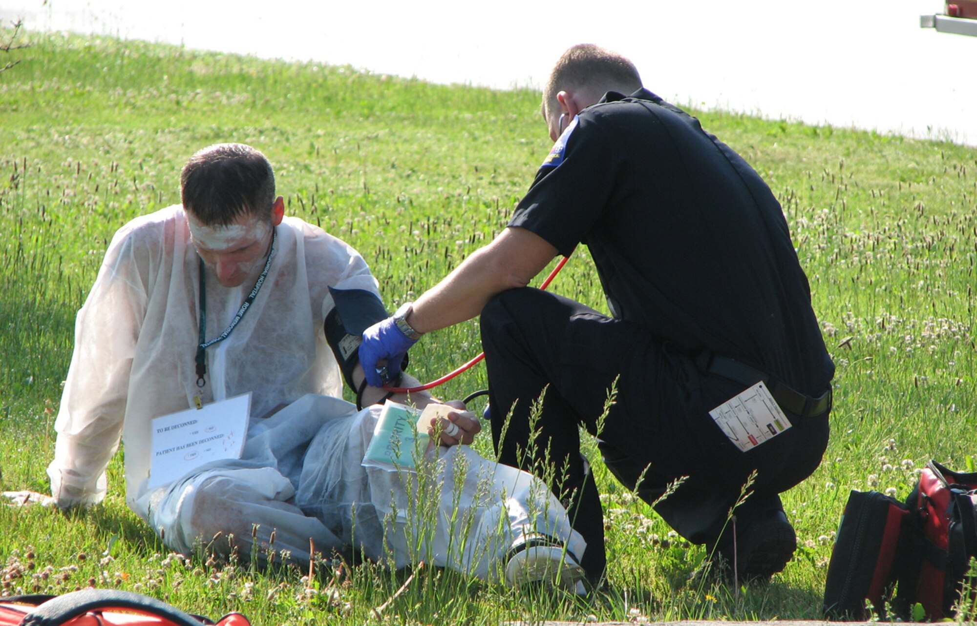A first responder looks after a simulated victim during the Griffiss Park exercise in June (photo by Brooke Davis).

