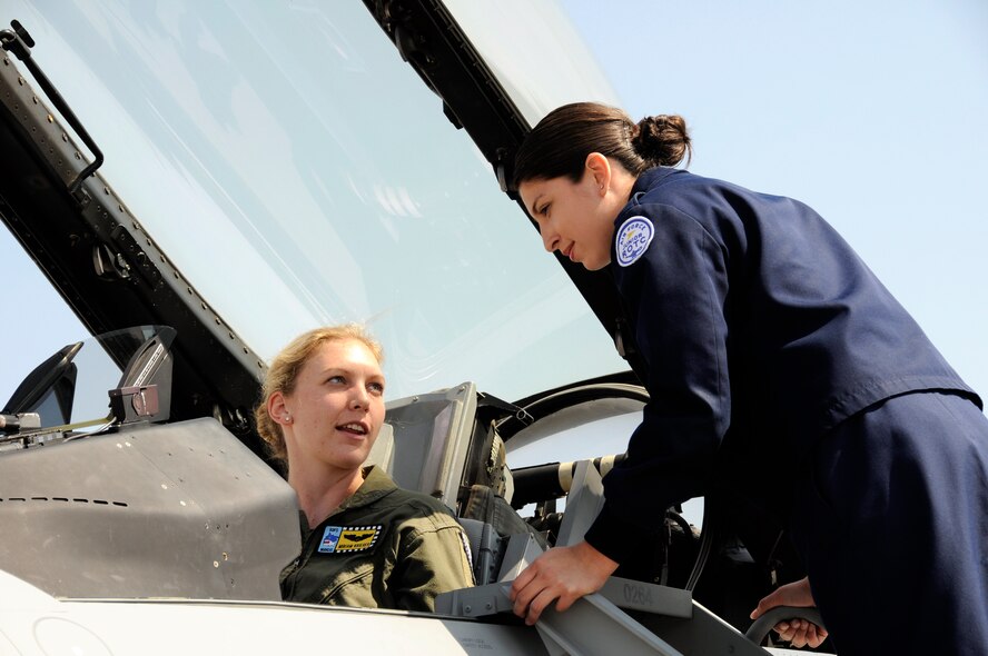 Capt. Miriam Krieger, 93rd Fighter Squadron pilot, answers questions while an Air Force Junior ROTC cadet peers into the cockpit of an F-16 on April 16.  The 28 cadets and chaperones from Kathleen High School, Lakeland, Fla.,  received tours and briefings from an F-16 pilot, air traffic control tower personnel, U.S. Customs and Border Protection and an up-close view of an F-16 take-off.   The group wrapped up their visit with lunch at the Falcons Nest club.  Homestead ARB offers two tours each month for students or community organizations. (U.S. Air Force photo/Tim Norton)