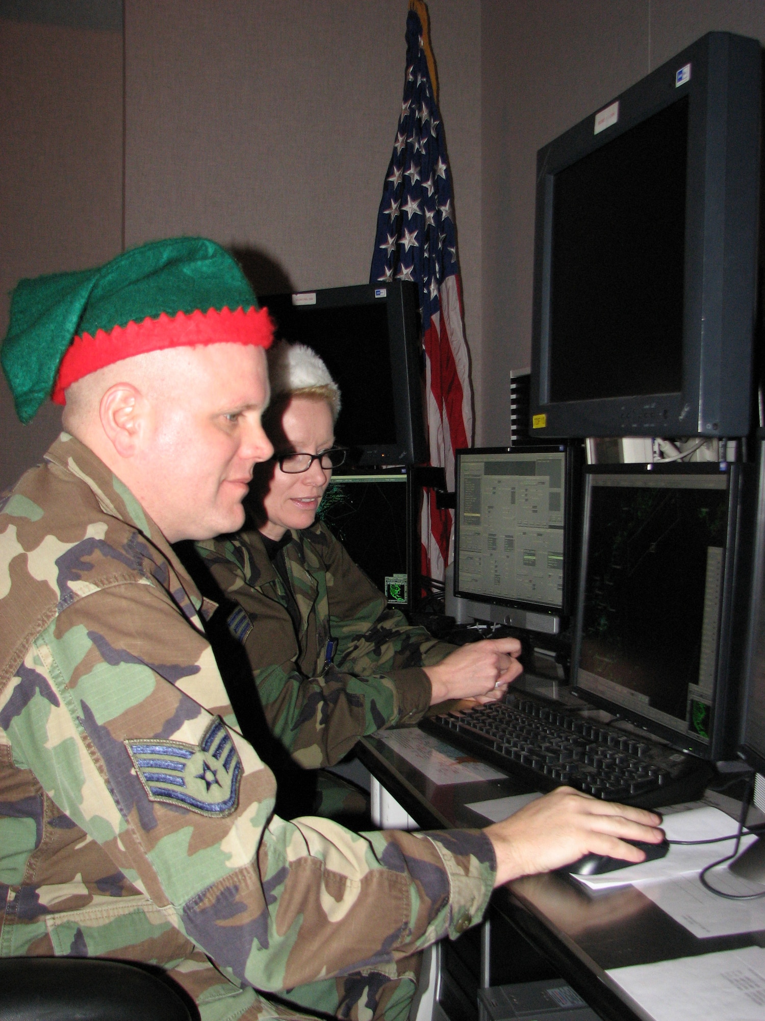 Two members of the Northeast Air Defense Sector prepare to track Santa using
their high-tech radar equipment. Staff Sgt. Deborah Martin and Staff Sgt.
Corey Reynolds make sure the high-tech radars that scan the sky above the
eastern United States and Canada are ready to go for St. Nick's annual ride
and the NORAD track Santa Program. NEADS is part of the North American
Aerospace Defense Command, which is the bi-national U.S.-Canadian military
organization responsible for the aerospace and maritime defense of the
United States and Canada. Each year, NORAD tracks Santa, and you can too by
checking out the Web site www.noradsanta.org -- the site features fun
holiday games and activities that change daily. (Photo by Brooke Davis)