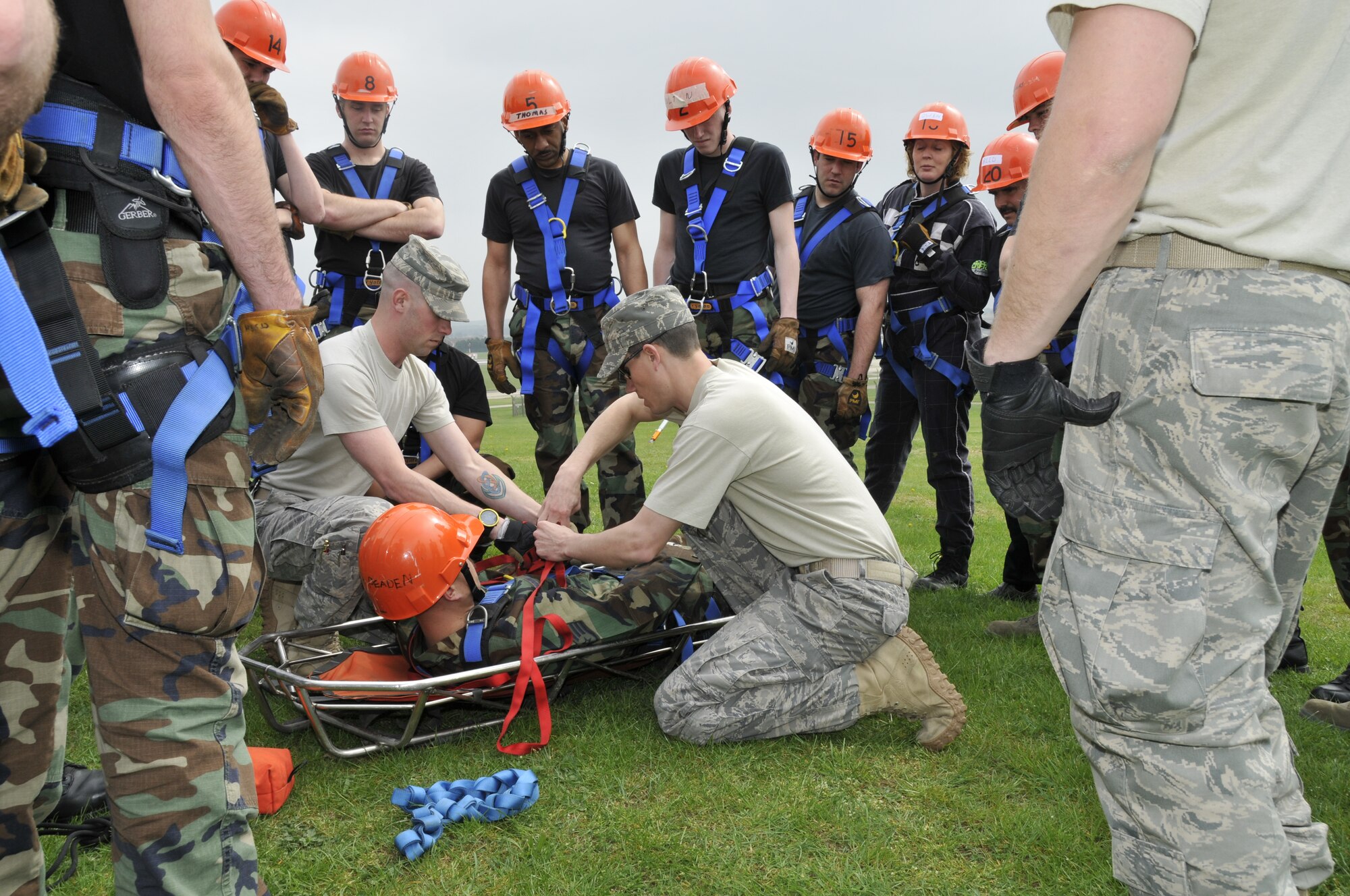 ROYAL AIR FORCE LAKENHEATH -- Instructors from the USAFE Fire Academy based out of Ramstein Air Base teach firefighters how to properly package a patient in the stokes basket here April 13, 2009. Firefighters from Lakenheath, RAF Mildenhall, and RAF Alconbury are participating in a 15 day Technical Rescue training course. (U.S. Air Force photo by Airman 1st Class Perry Aston) (Released)