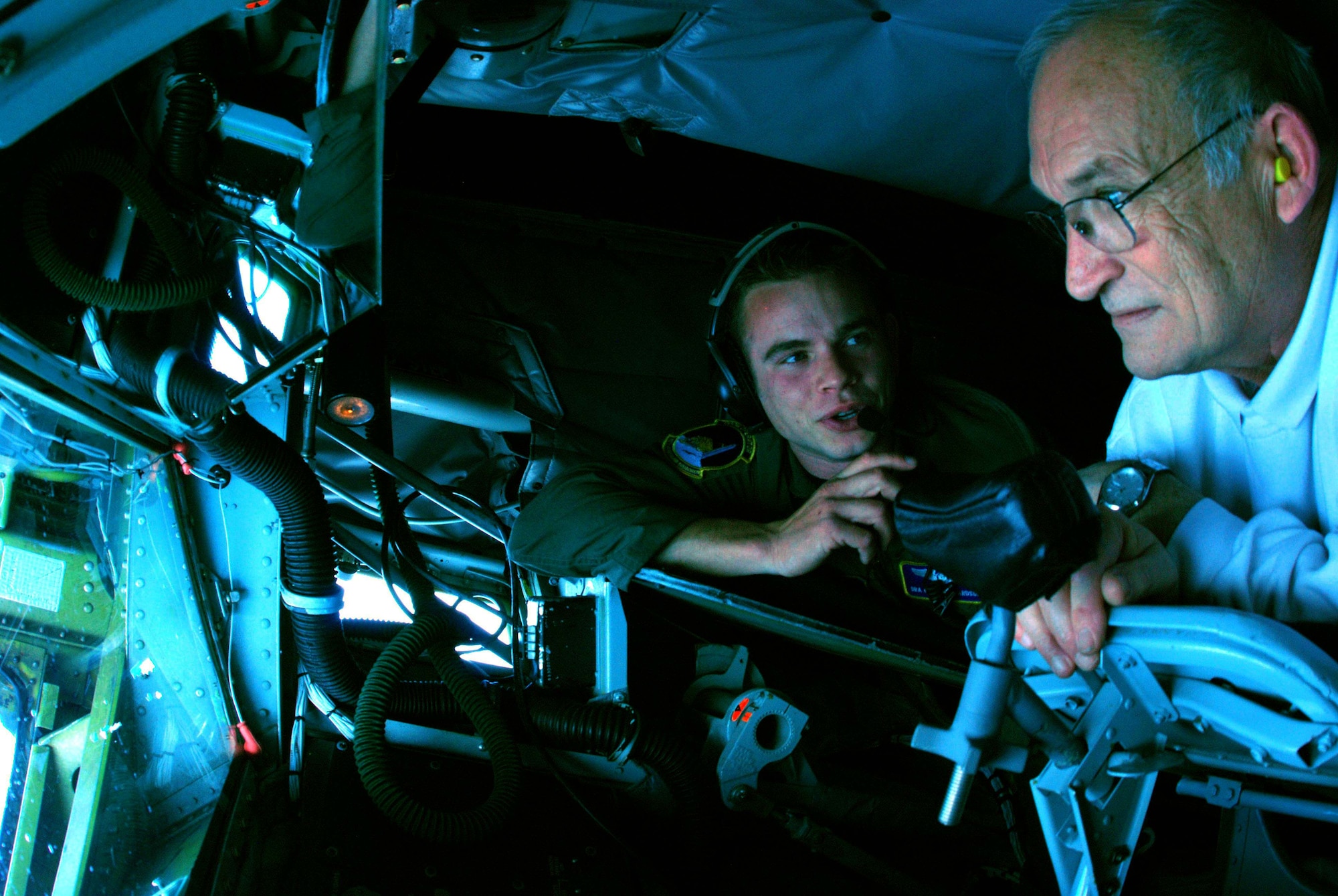 Senior Airman Geoffrey Richardson, 756th Air Refueling Squadron boom operator, explain controls and his responsibilities to Lee Schiek, 459th Air Refueling Wing honorary commander during an orientation flight April 3. (U.S. Air Force photo/ Senior Airman Ashley Crawford)
