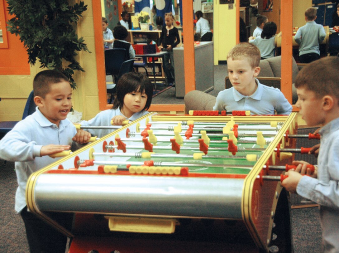 A group of Andrews youngsters play foosball in the game room after school at the Andrews Youth Center Wednesday. (U.S. Air Force photo/ Bobby Jones)
