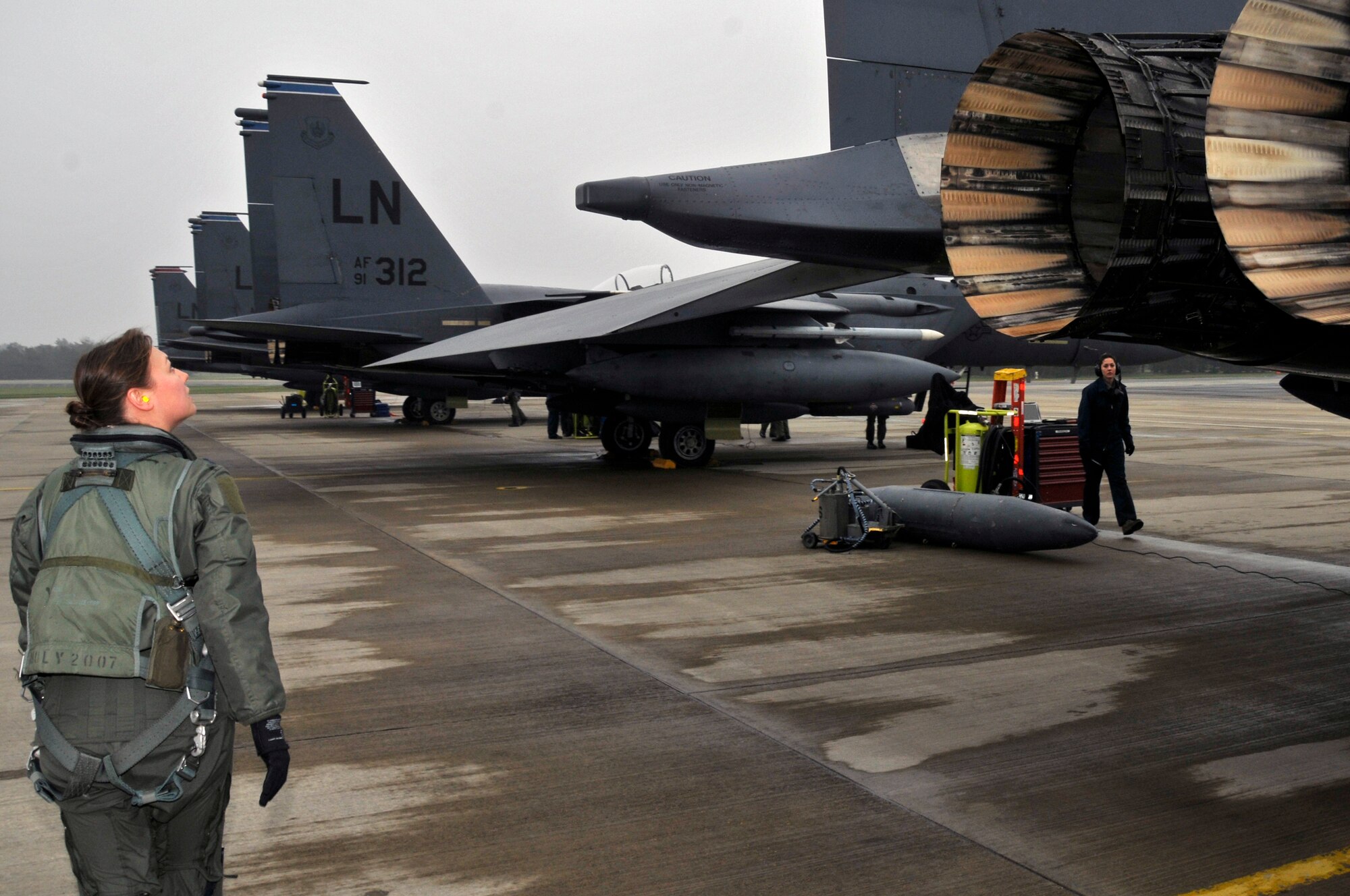 ROYAL AIR FORCE LAKENHEATH, England -- Captain Cathyrine "Lilo" Riddersen, 494th Fighter Squadron weapon systems officer performs preflight inspections prior to deploying to Campia Turzii, Romania as part of exercise Strike Lance 2009 here April 17, 2009. This exercise will allow the 494th Fighter Squadron an opportunity to train against MiG-21Ls. (U.S. Air Force photo by Airman 1st Class Perry Aston) (Released)
