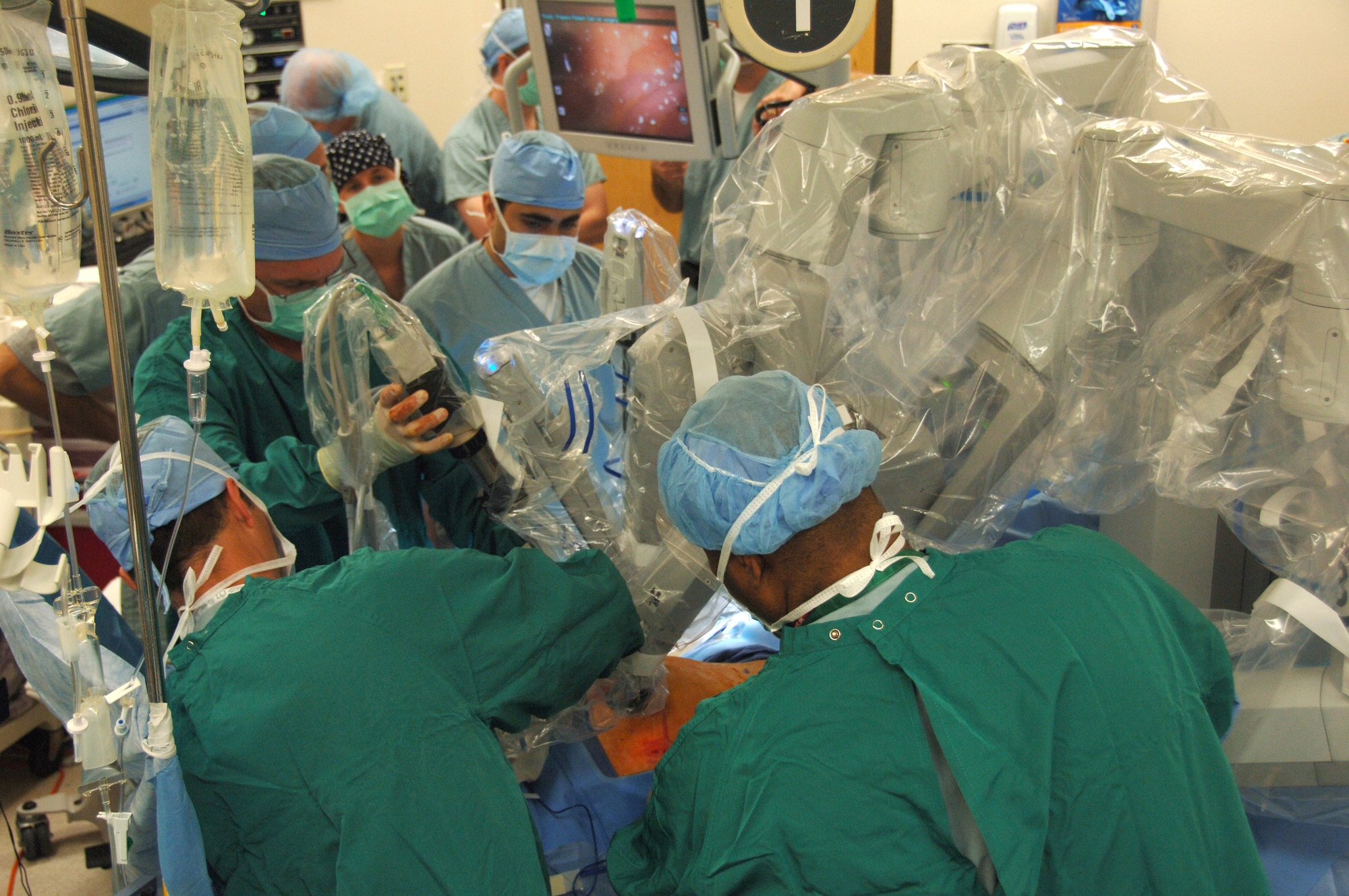 A robot is put into place by doctors for a laparoscopic prostatectomy, or the surgical removal of prostate cancer, on April 10 at Wilford Hall Medical Center, Lackland Air Force Base, Texas.  This was the first robot-assisted surgery in the Air Force and was performed by Lt. Col. (Dr.) Kyle Weld, director of endourology, 59th Surgical Specialties Squadron.  More robot-assisted surgeries are scheduled at Wilford Hall.  (Air Force photo by Senior Airman Nicole Roberts)   
